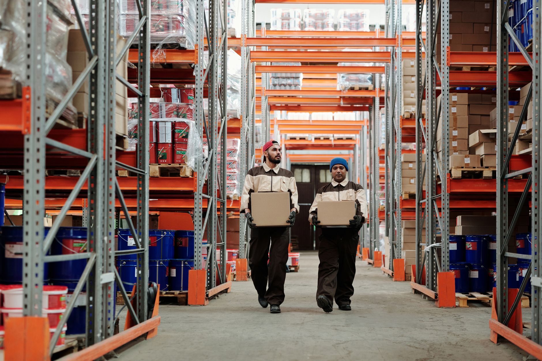 Cartons staged in a fulfillment center where AMR-assisted picking replaces long manual cart walks.