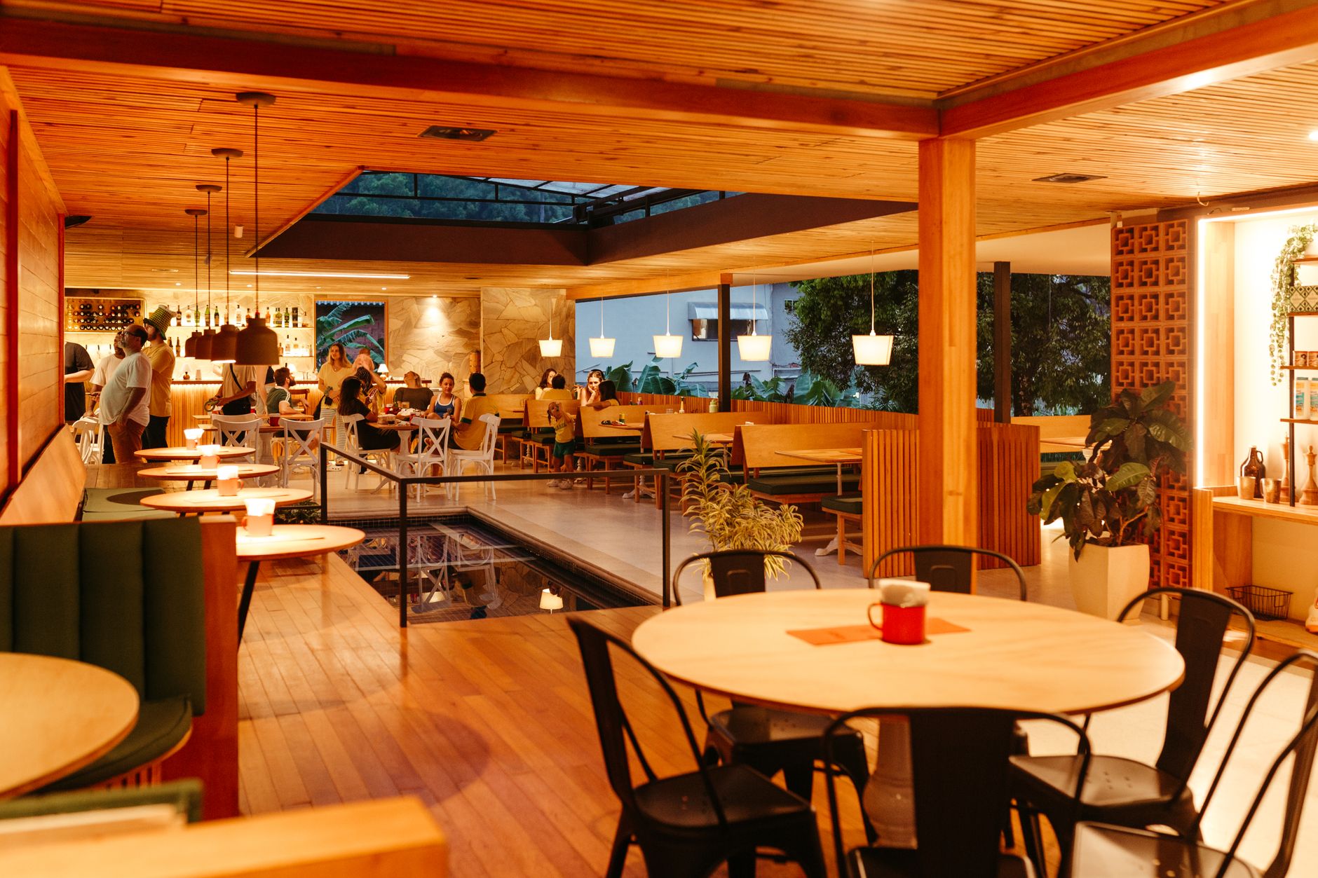 Guests seated at a full-service restaurant while staff stay visible on the floor.