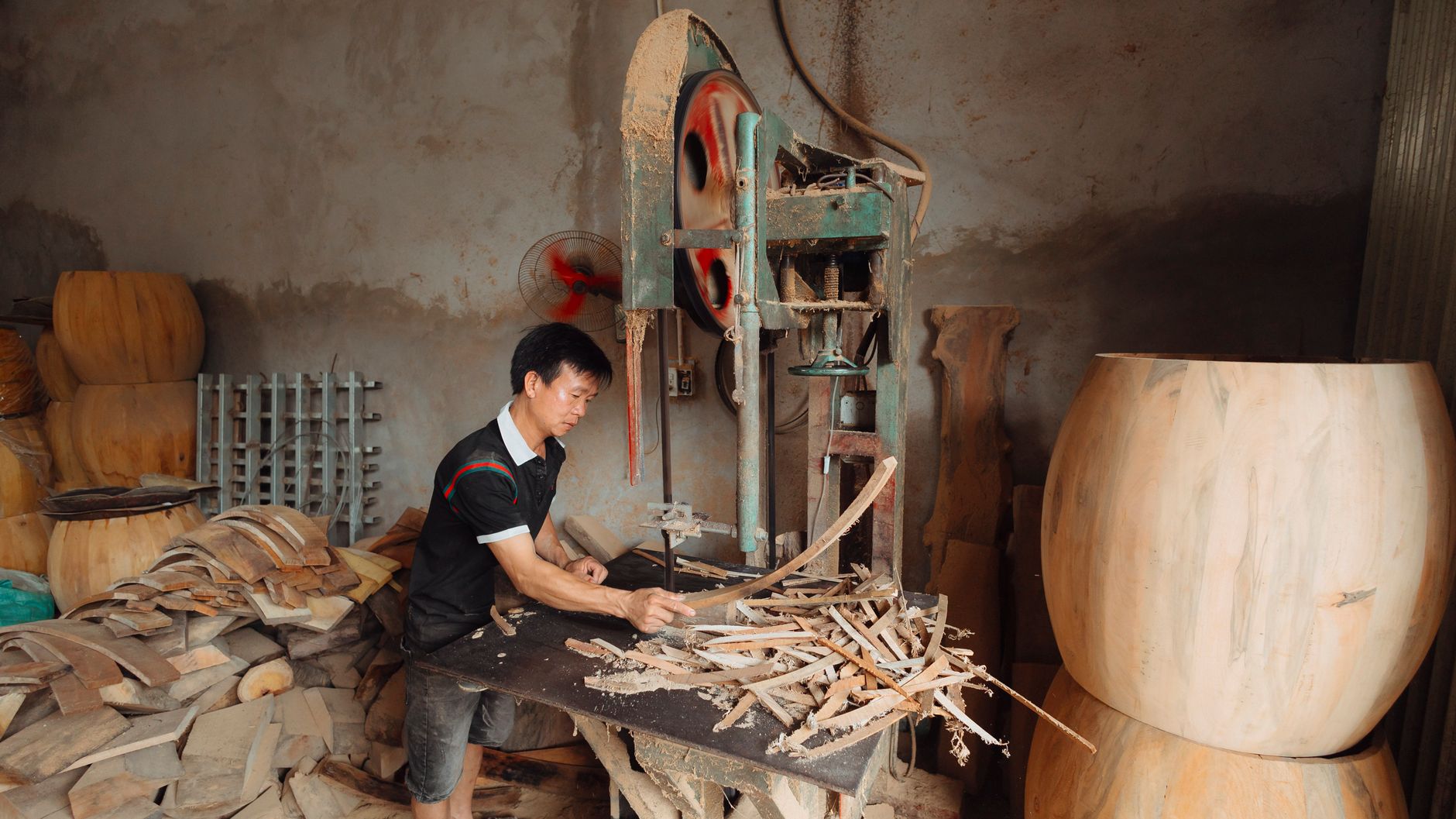 Workers and materials occupy a large wood furniture manufacturing floor.