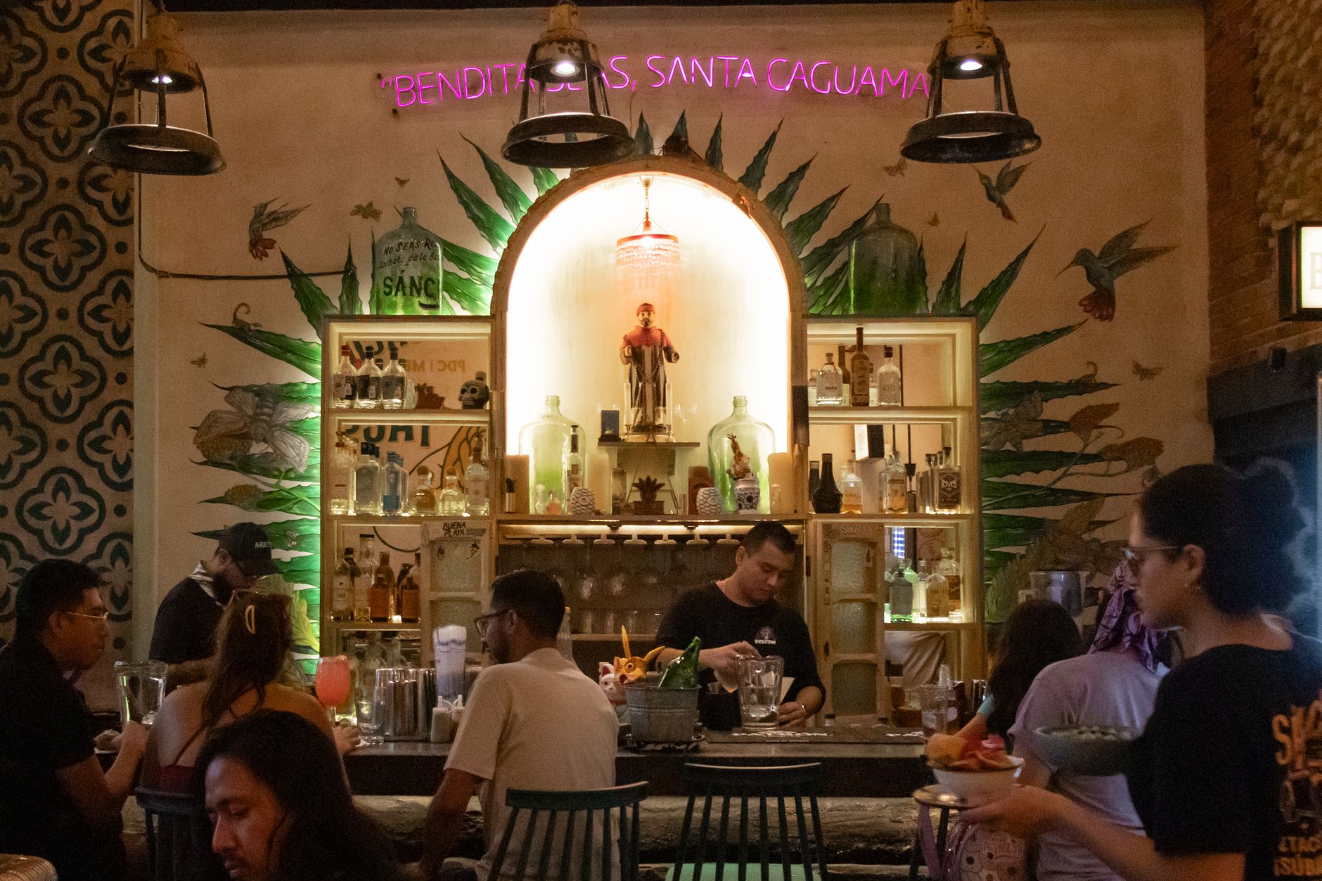 Warm, busy interior of a full-service Mexican restaurant during a dinner rush, setting the scene for staffing pressure on the floor.