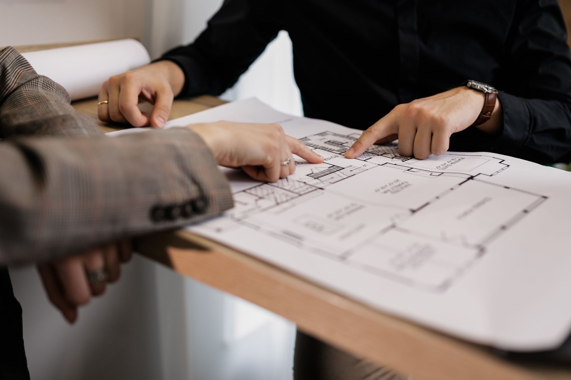 Operations staff review a floor layout during a logistics planning session.