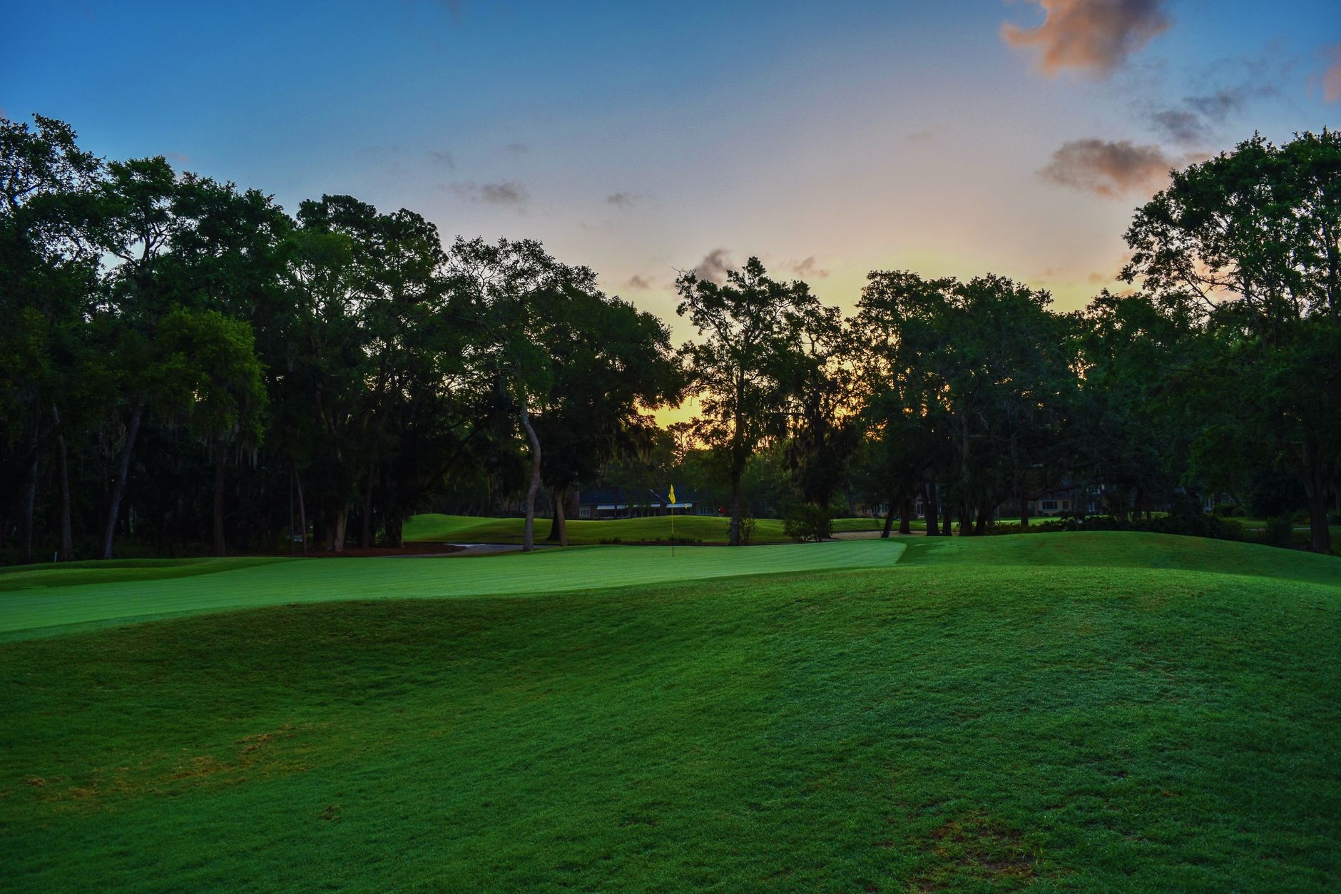 Sunrise light falls across the fairways of a Southern California golf course.