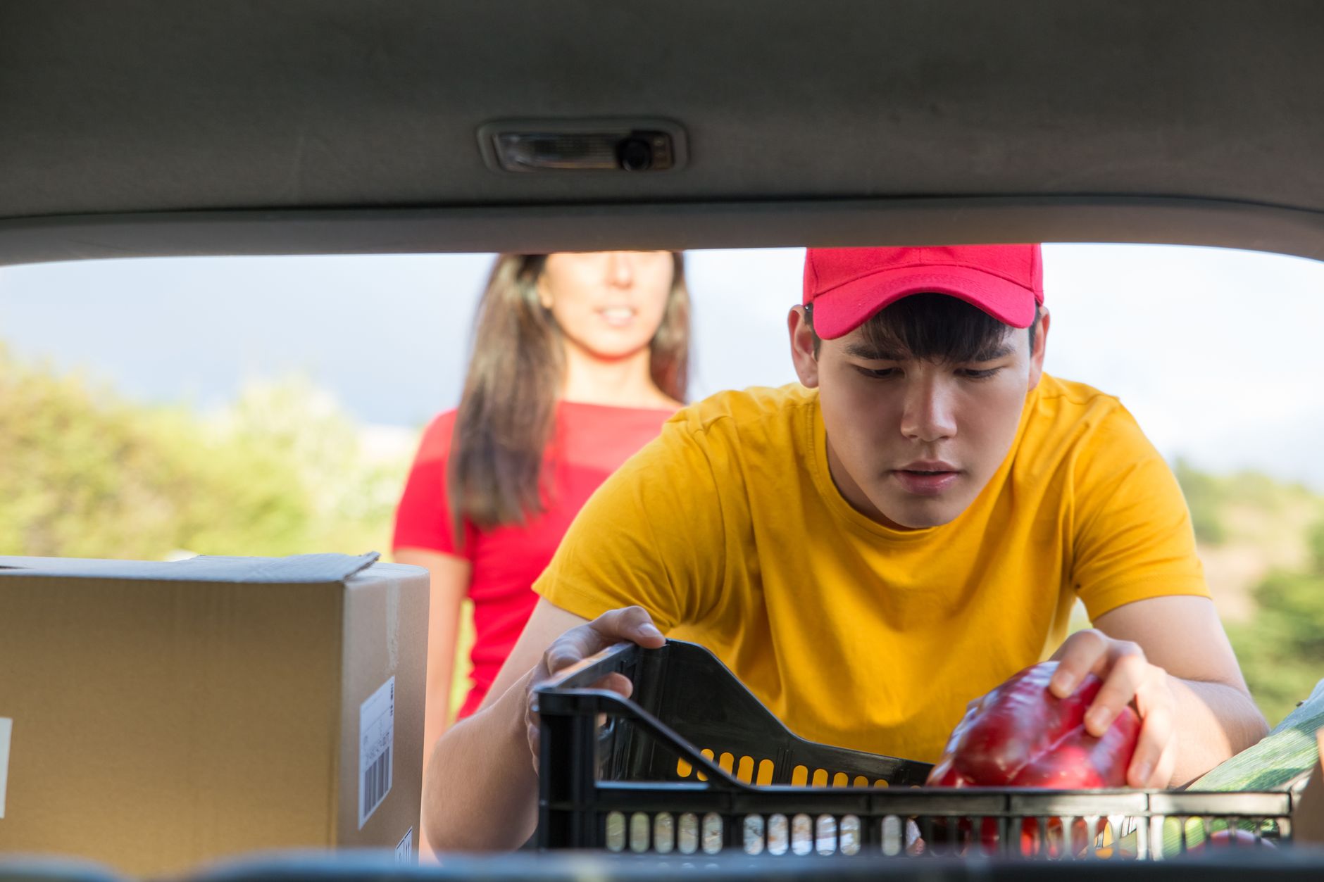 A grocery worker picking items in a supermarket aisle, illustrating the repeatable in-store operations needed to scale delivery across many locations.