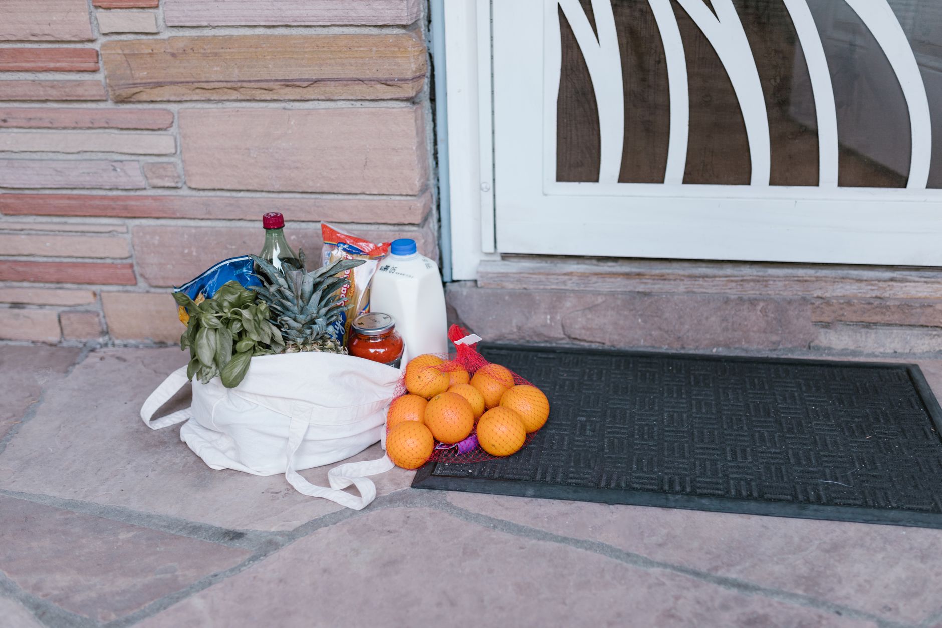 Grocery bags set at a residential doorstep, reflecting the fast completed deliveries and everyday household use described in the results.