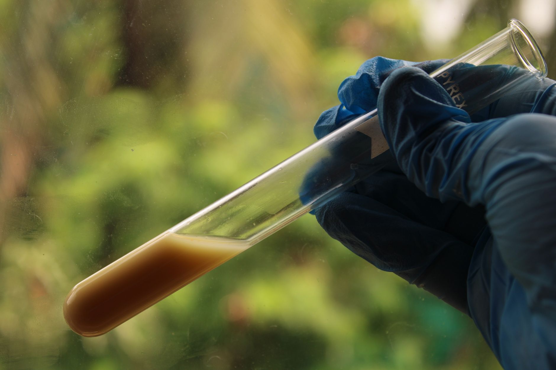 A waterfront worker collects a water sample as part of routine harbor water-quality management.