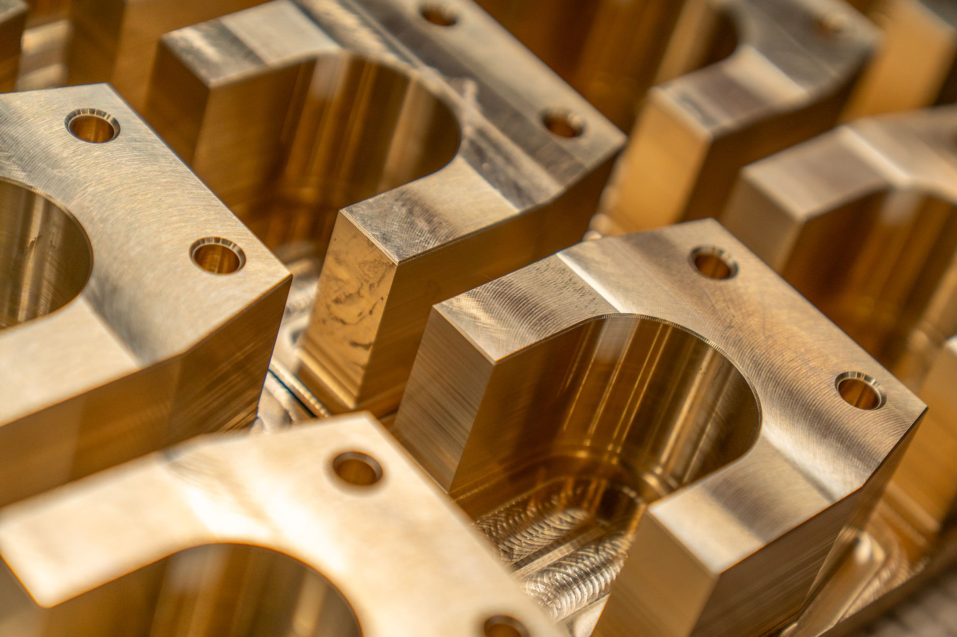 Finished metal components arranged beside a machining workstation.