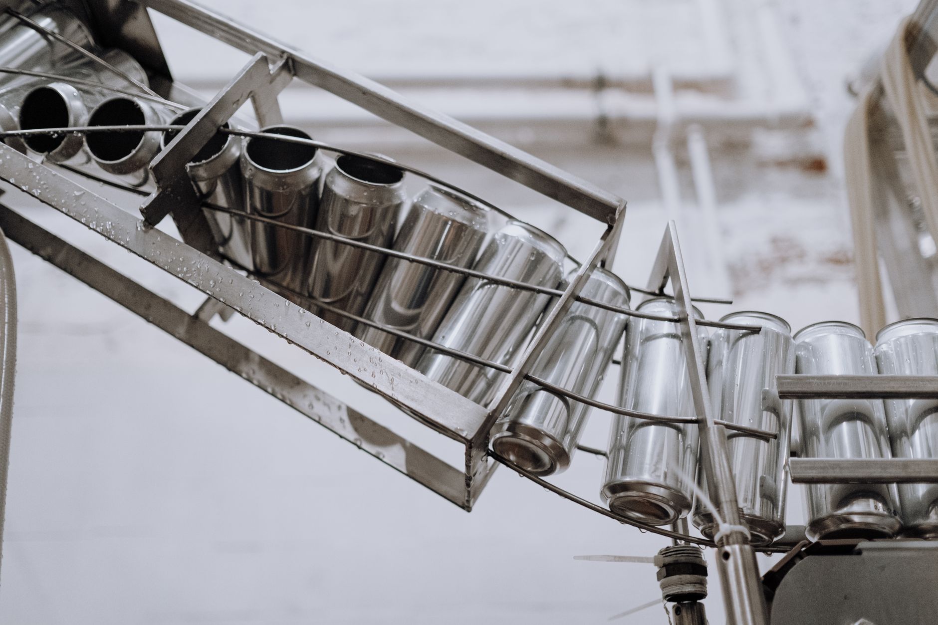 Finished metal components moving along a factory outfeed conveyor.
