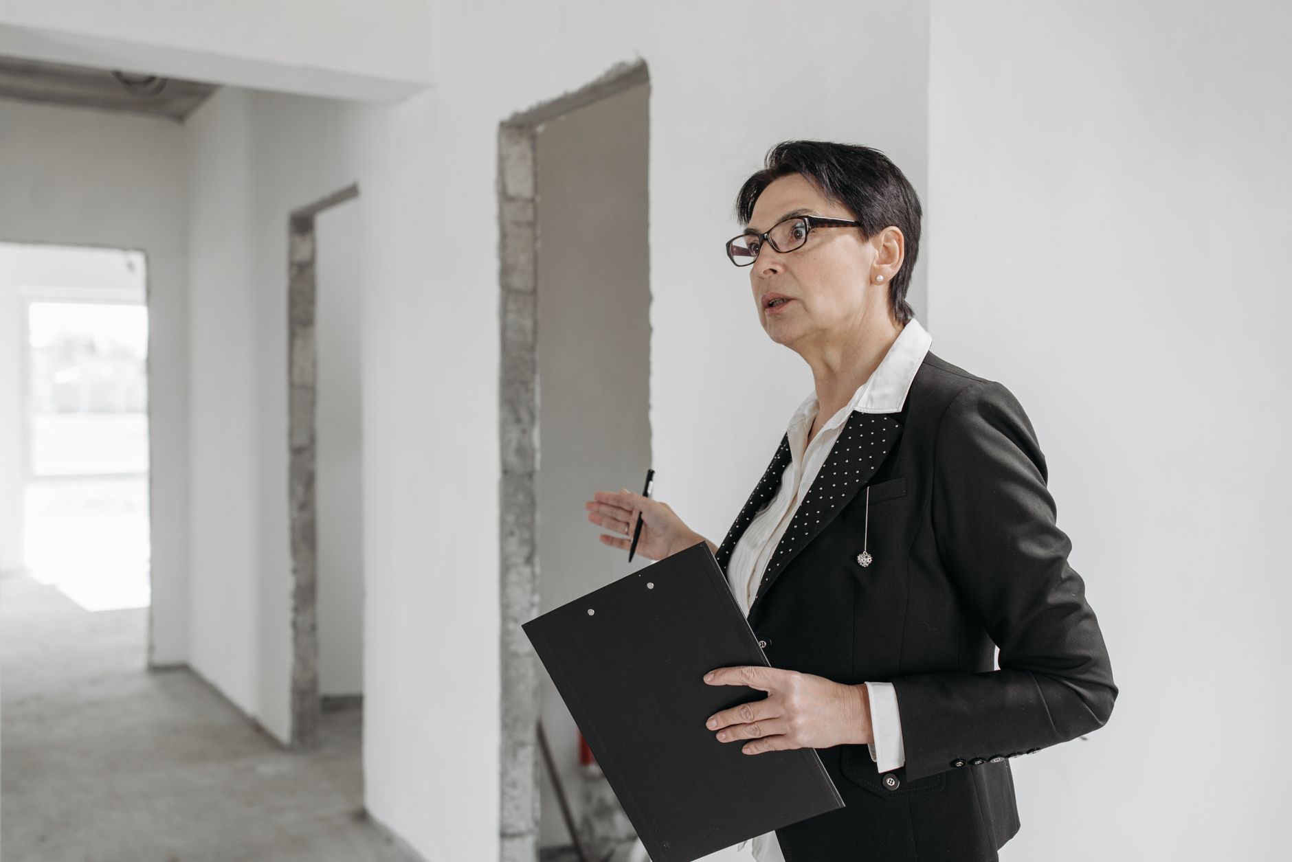 An operations team member inspecting a commercial building exterior before planning a facade cleaning rollout.