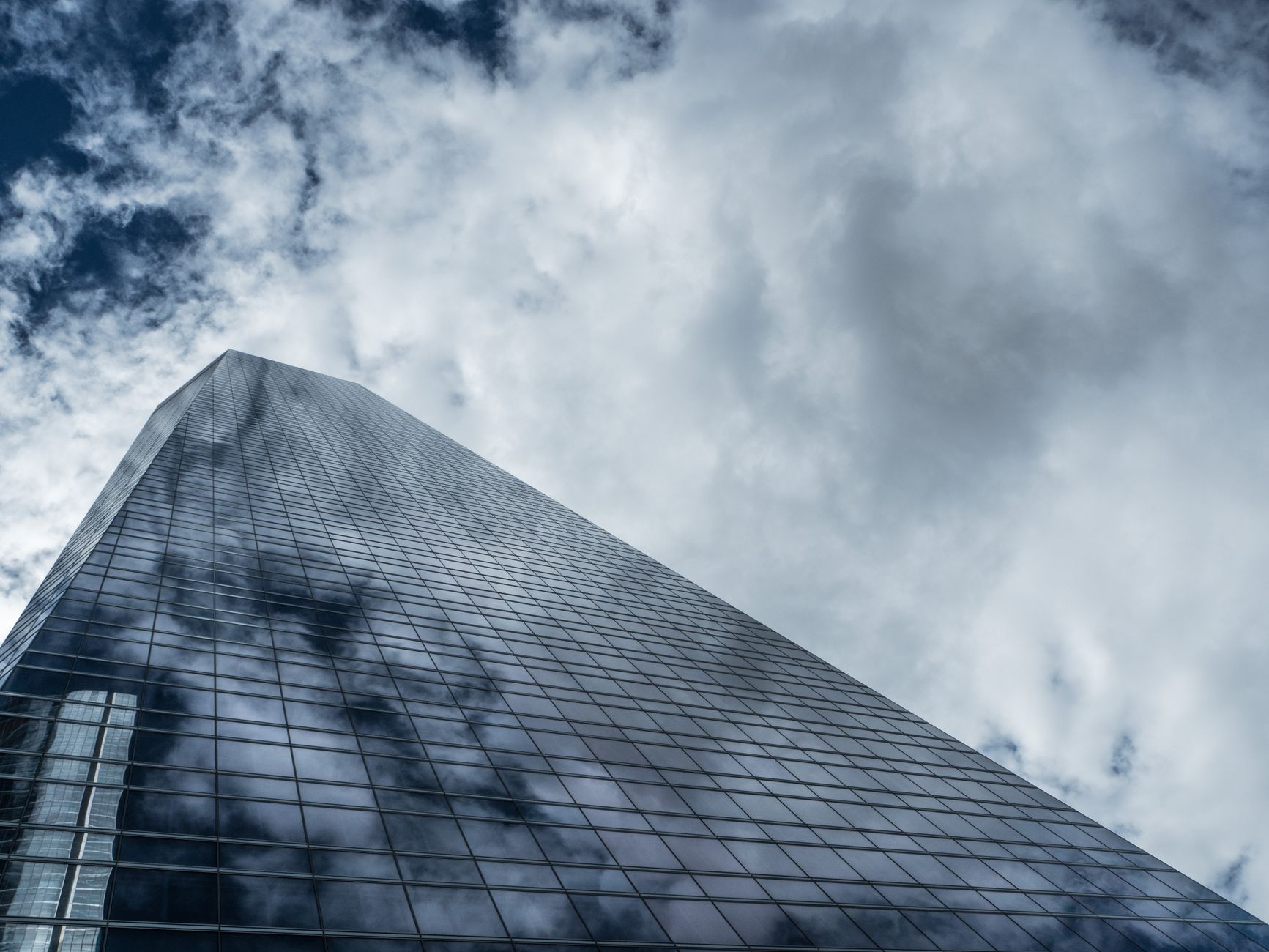 A tall glass office tower rising above the street, representing the kind of high-rise facade cleaned in the case study.