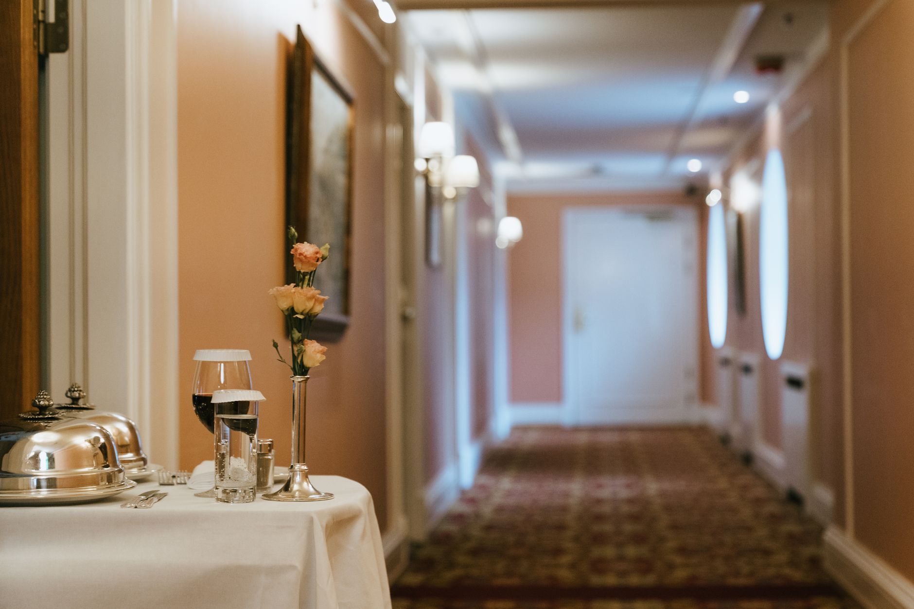 A long indoor restaurant corridor where staff would walk sealed delivery bags from the kitchen to a distant pickup window.