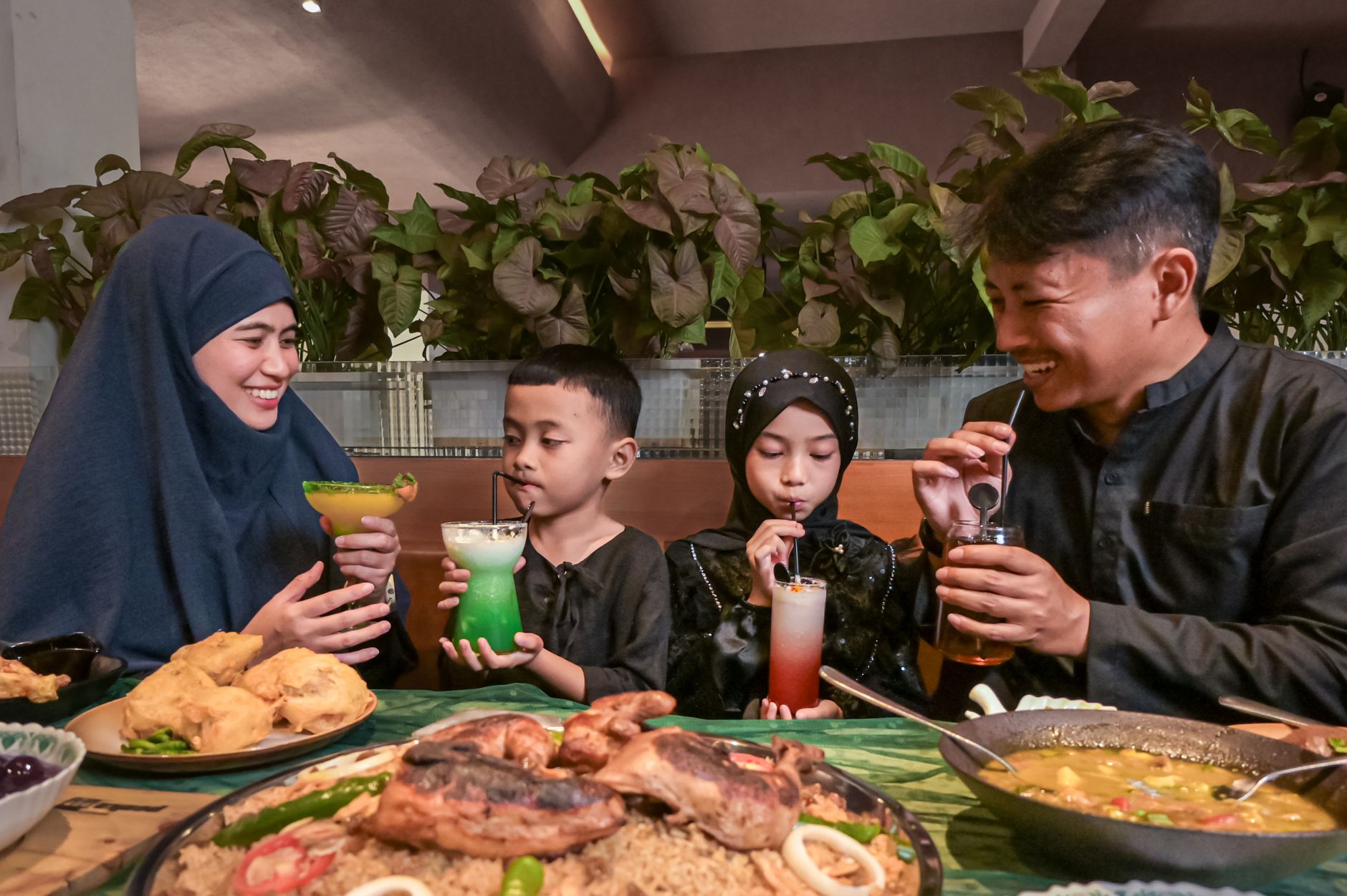 Guests seated in a large family-style restaurant dining hall during a busy meal service.