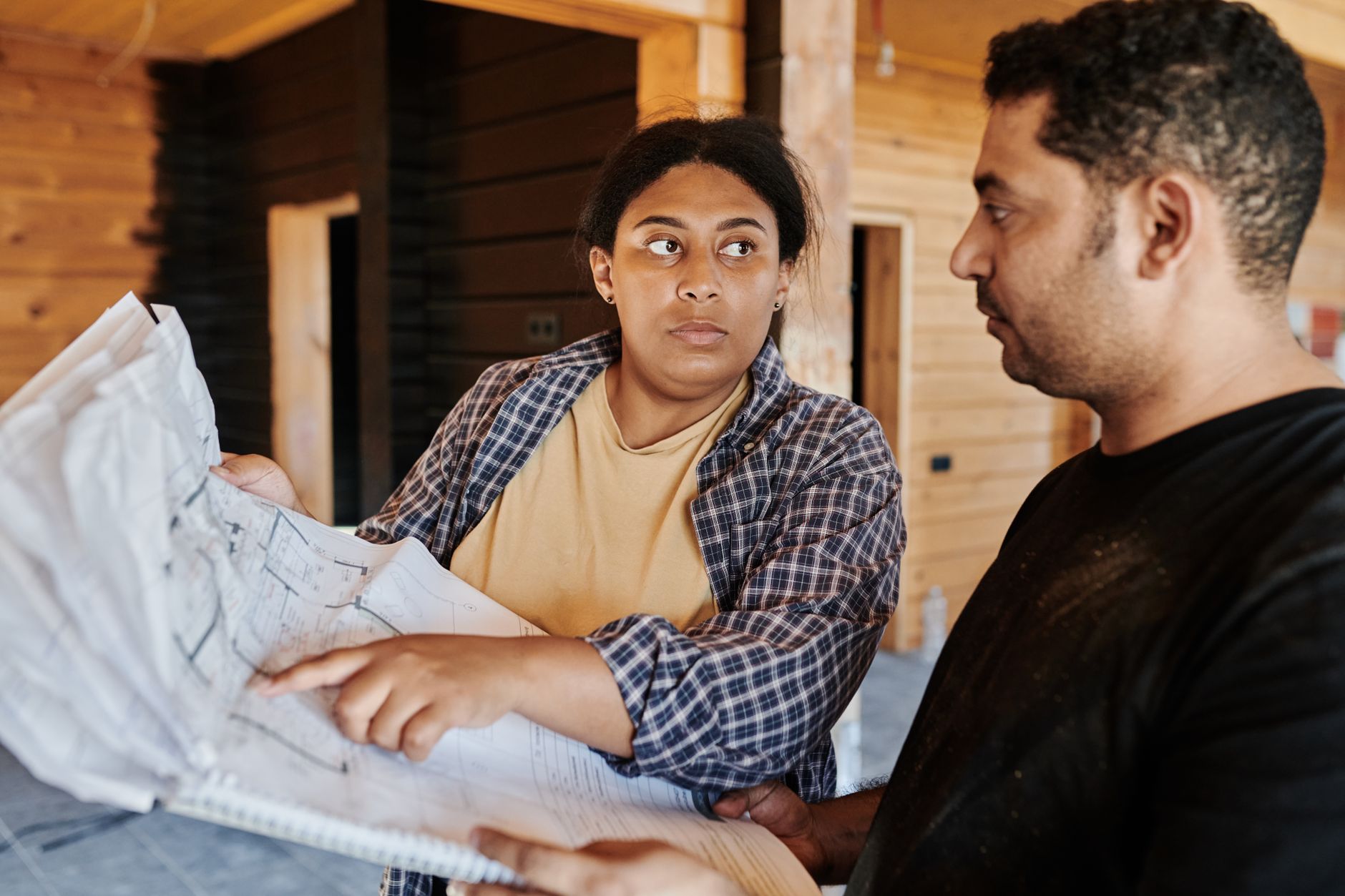 Construction contractors review project plans before selecting equipment for a tight-access job.