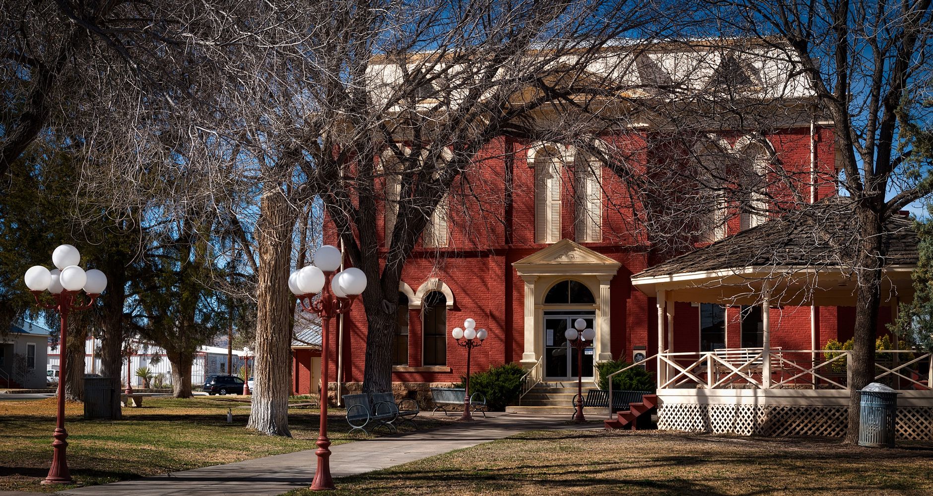 A historic brick civic building stands in a New England streetscape during renovation.