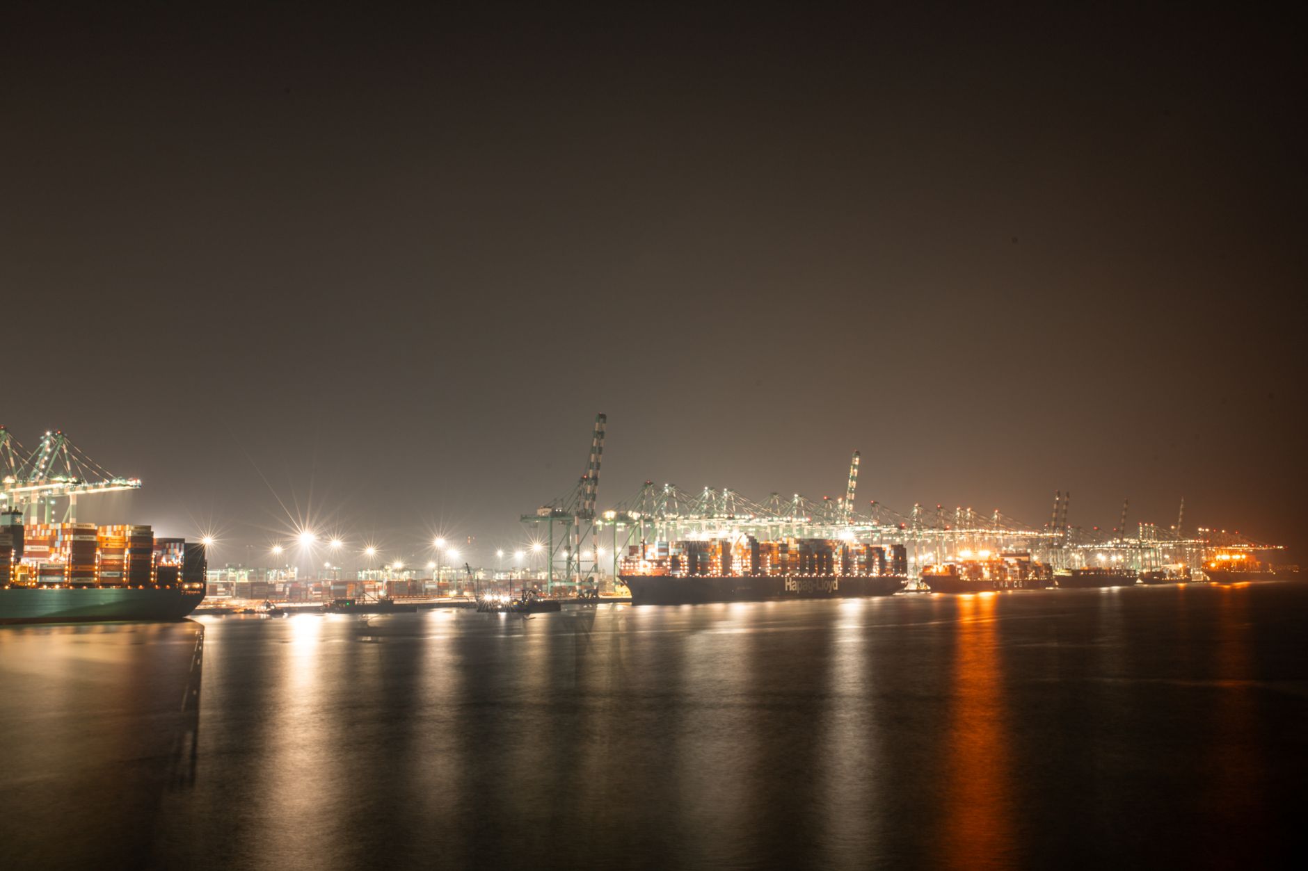 Container freight near a Southeast port, echoing the logistics hub that feeds the automated home goods building.