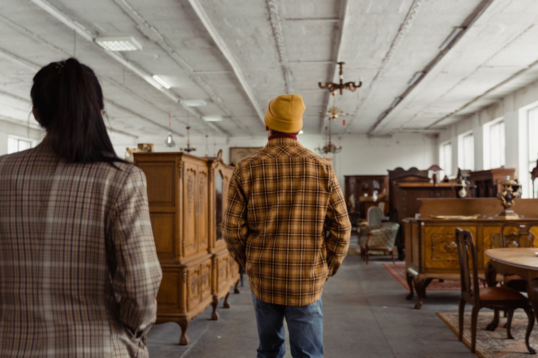 Cartons of home furnishings stacked in a fulfillment warehouse aisle served by automated transport.