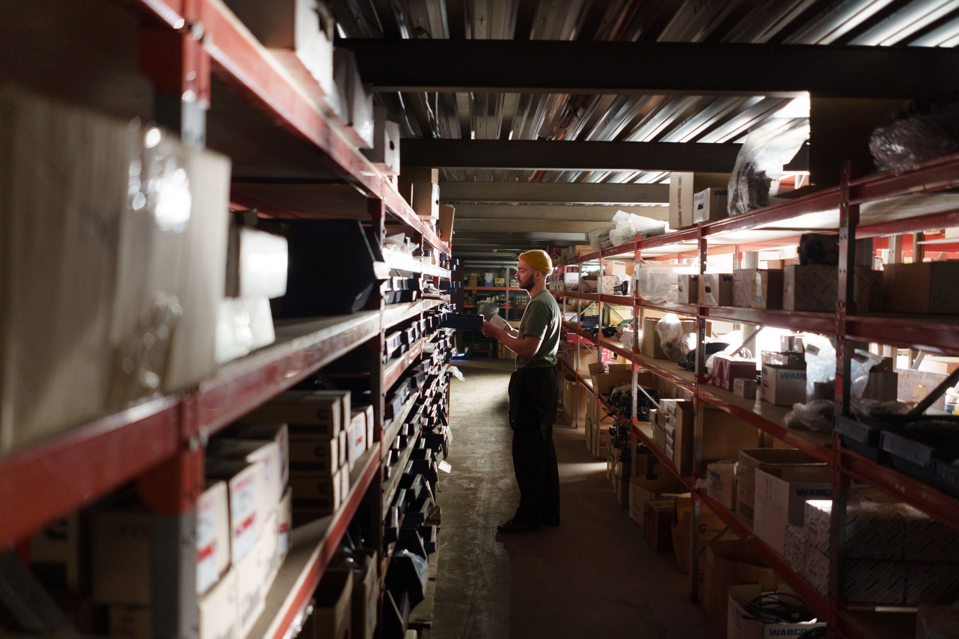 A store manager reviewing shelf conditions in an aisle, reflecting the article's pilot-to-rollout operating discipline.