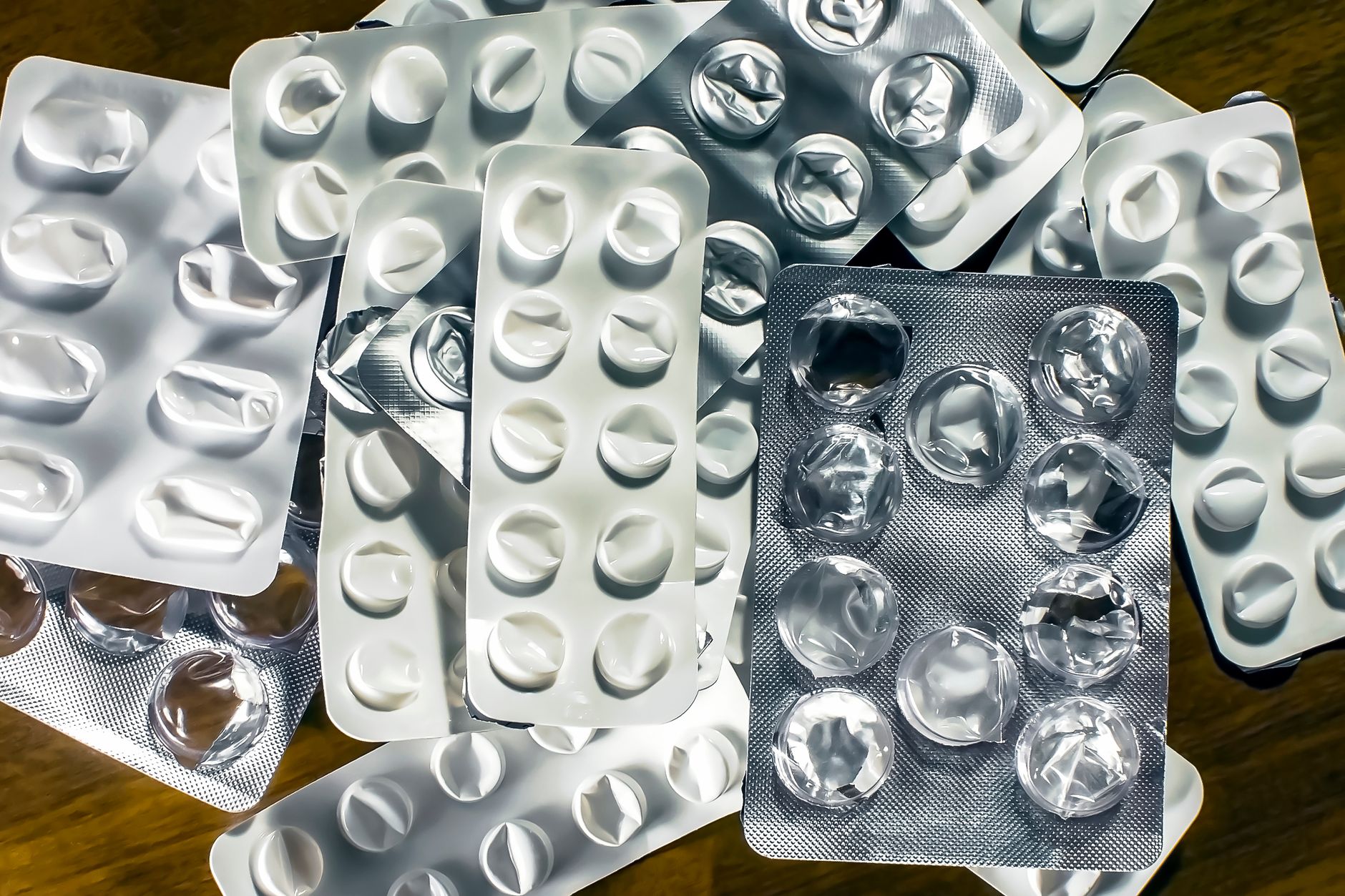 A pharmacy worker sorts packaged medicines as part of the hospital dispensing workflow.