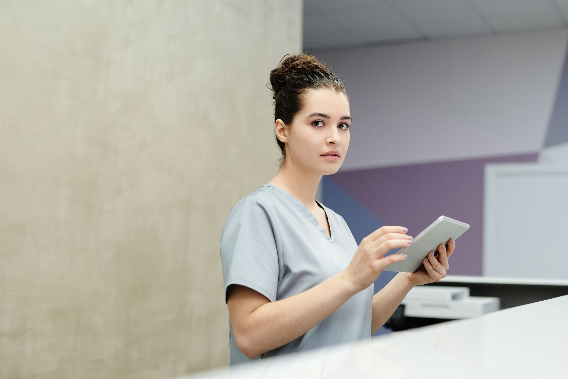 Staff coordinating discharge paperwork as beds turn faster after shorter stays.