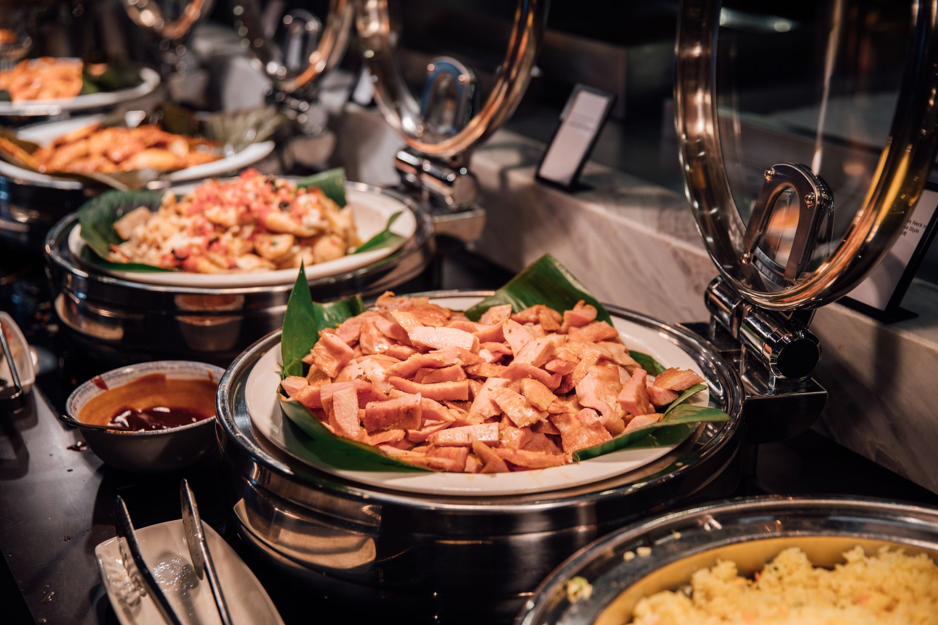 Wide view of an upscale hotel buffet restaurant, matching the kind of dining room where staff must keep tables clear and service polished throughout the day.