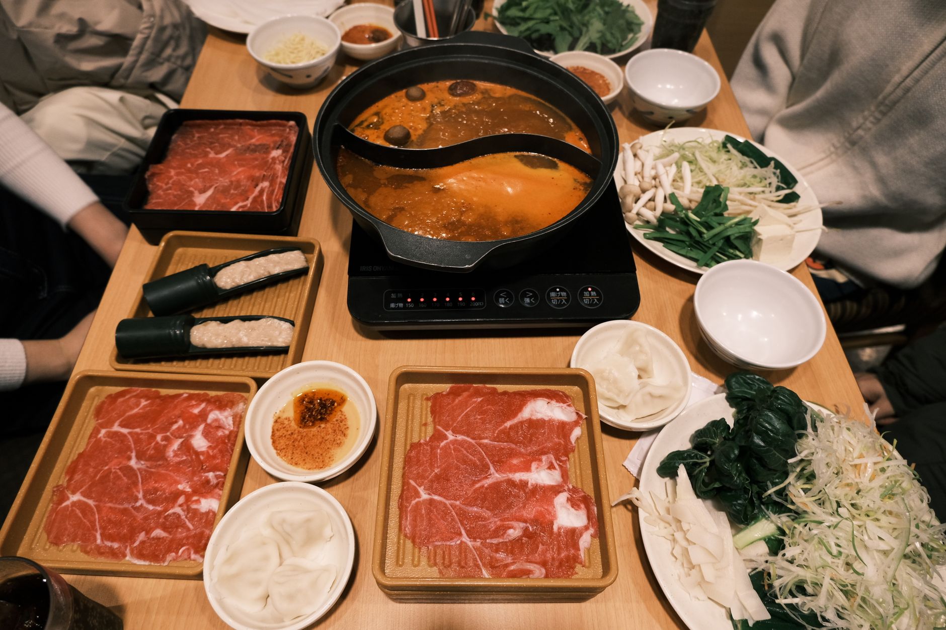 A busy hotpot dining room illustrates the high-volume service environment examined in the case study.
