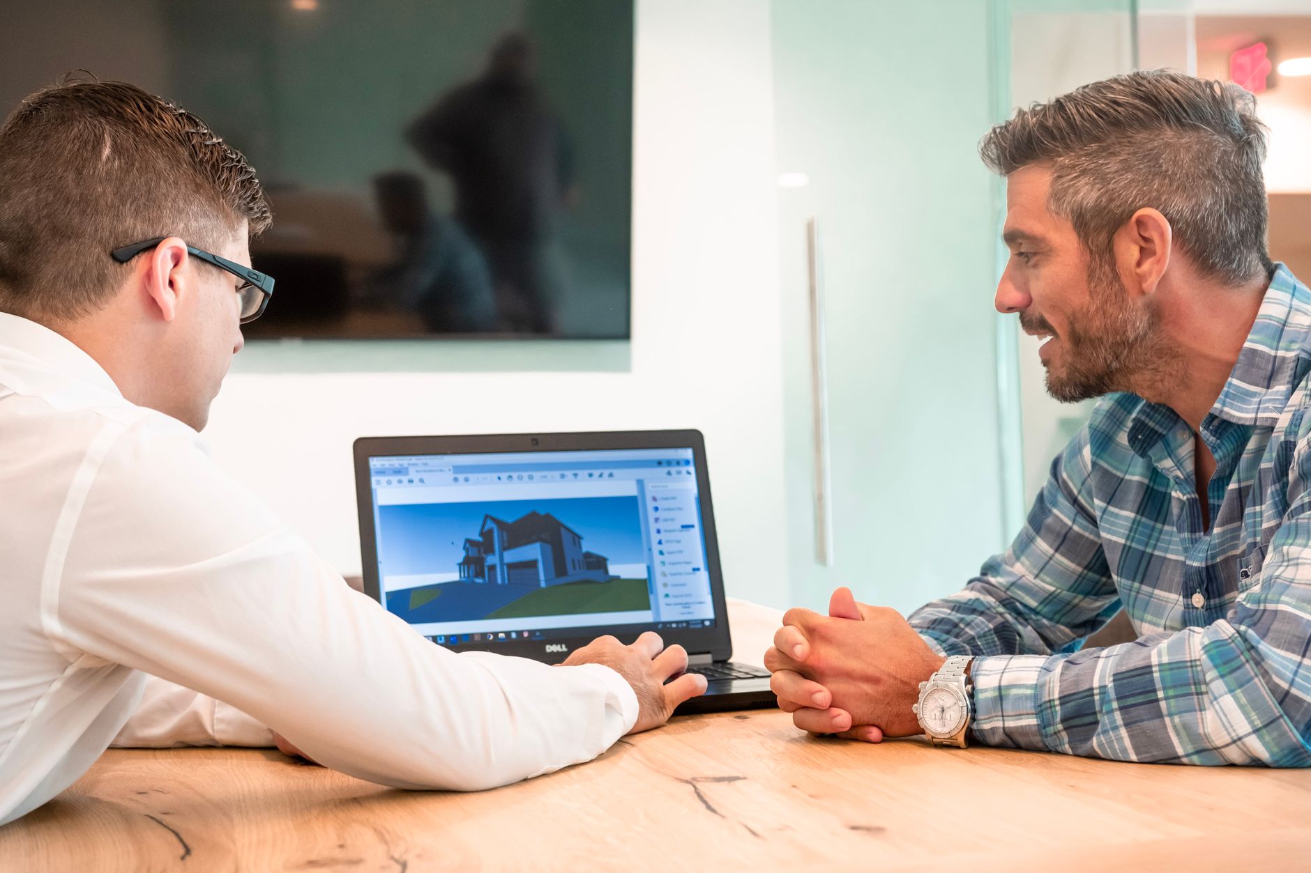 An engineer reviewing a detailed digital model on a laptop, standing in for desk-side crack review.