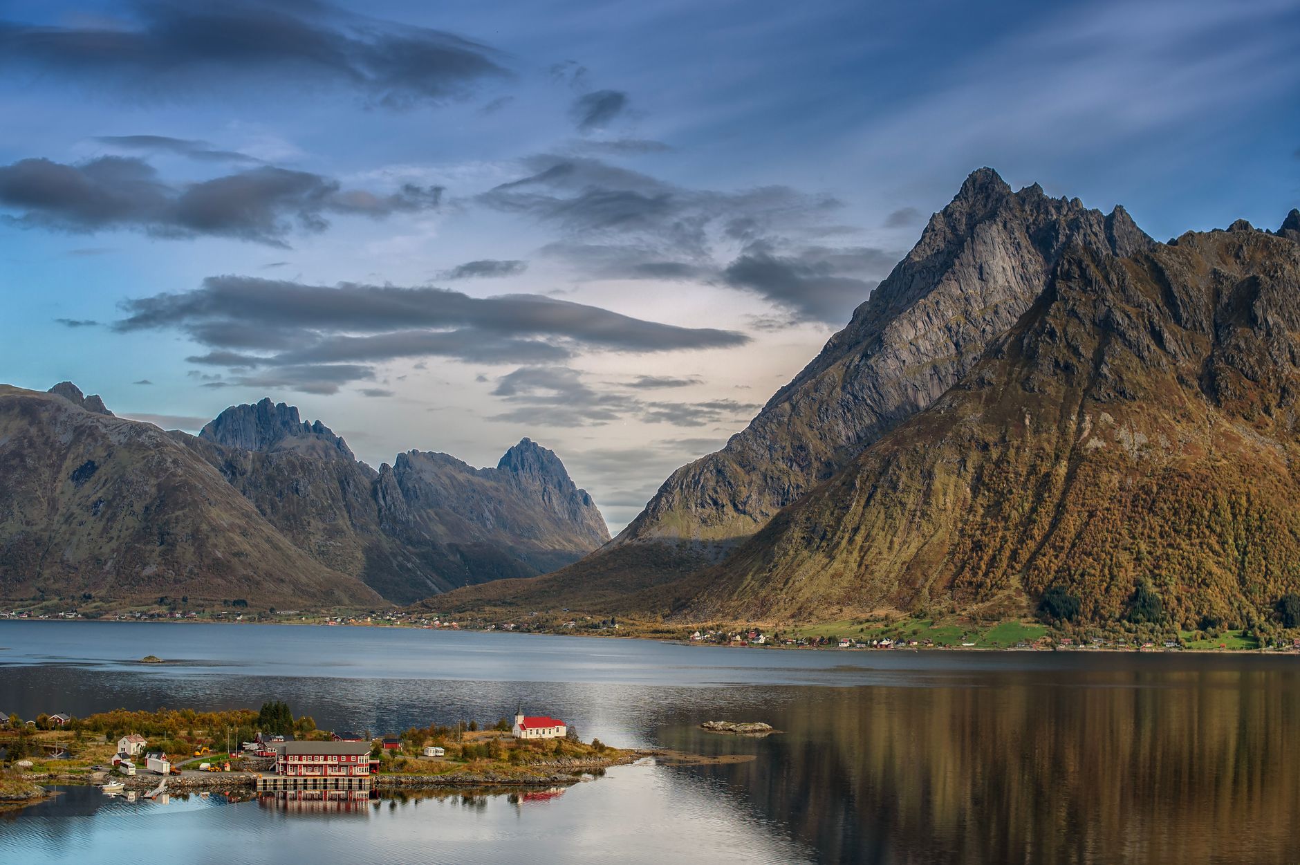 Rocky Norwegian coastline where open-net fish farming operations are common.