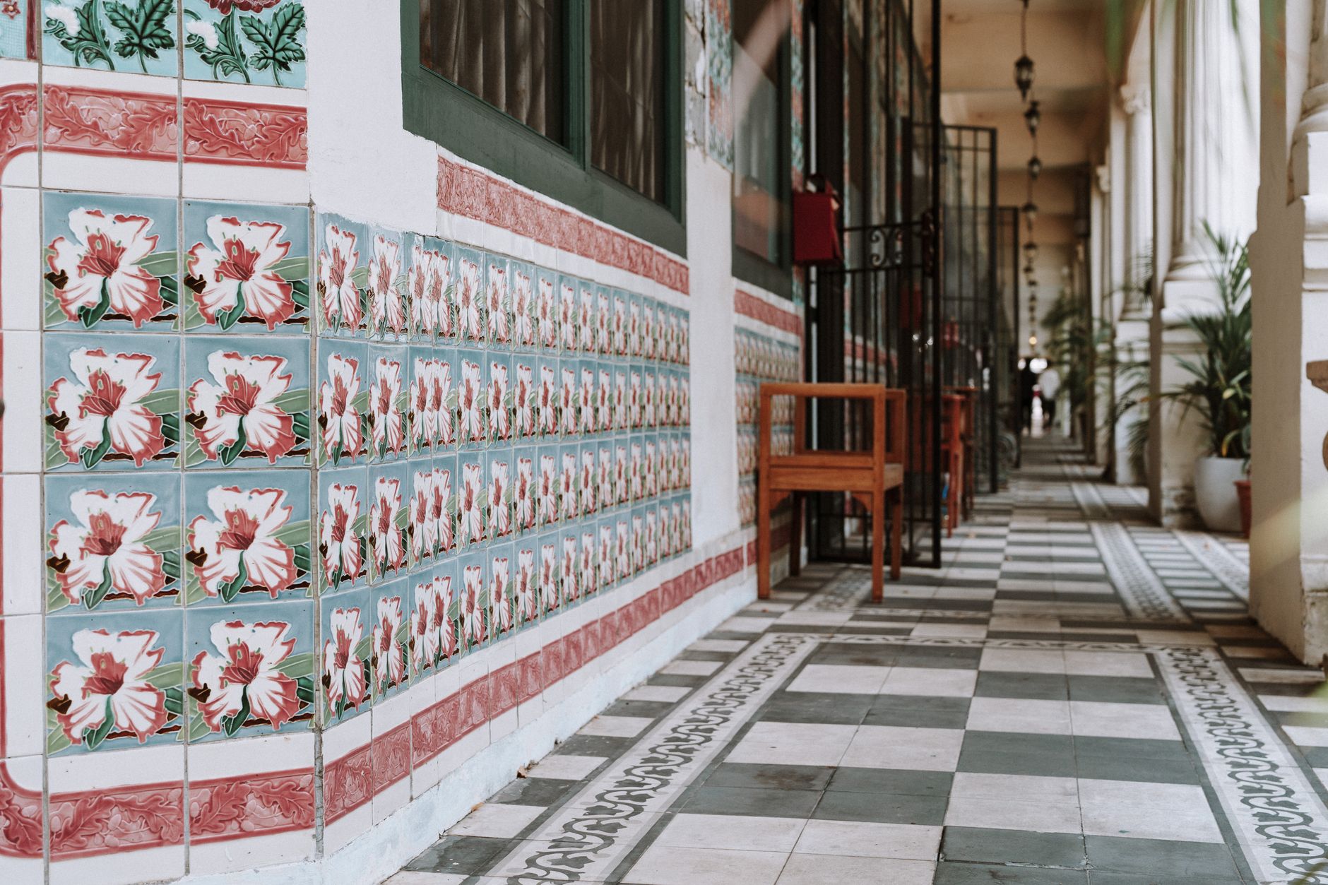 Long tiled corridor in a civic building where daily floor care must finish before visitors arrive.