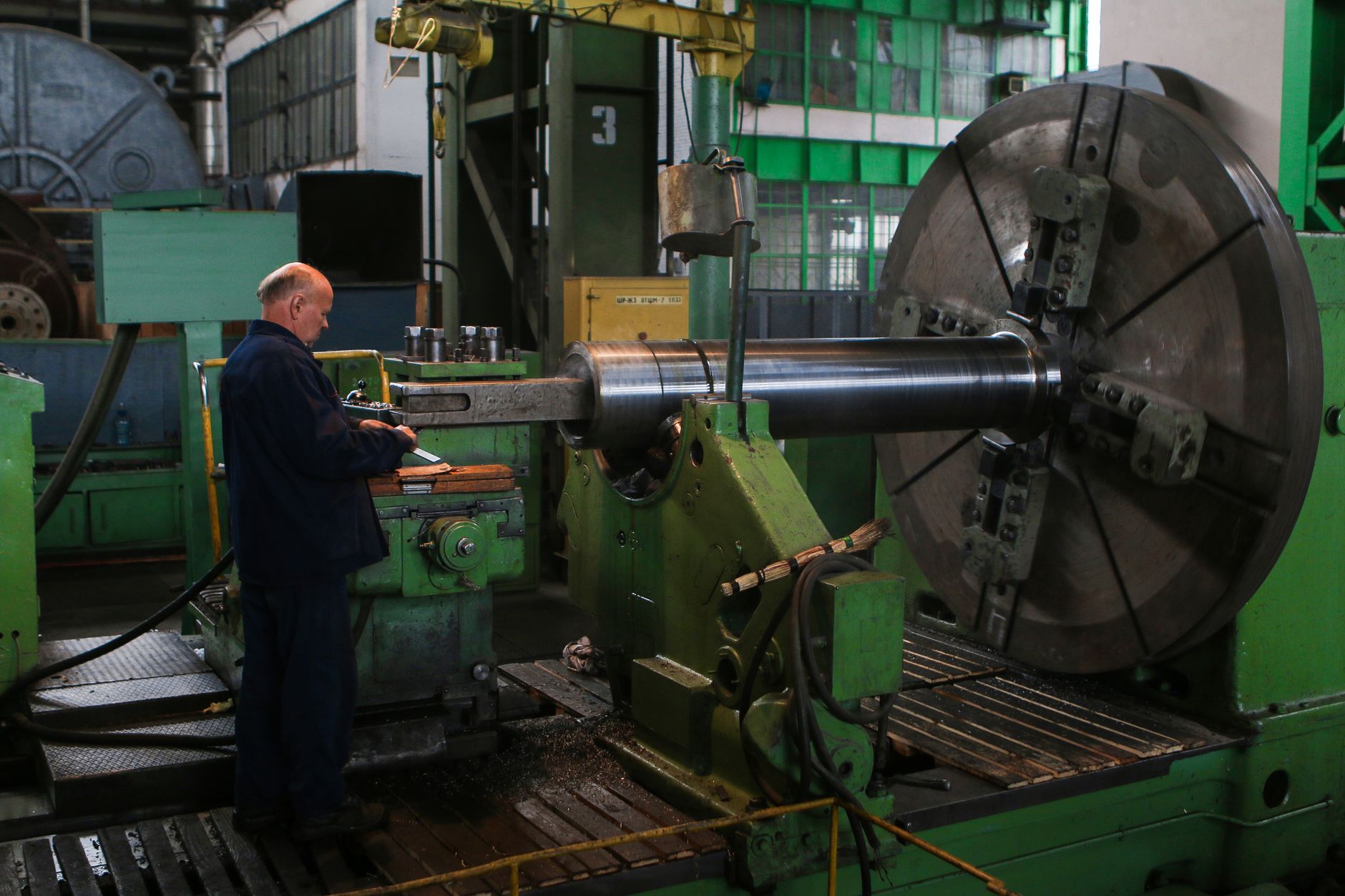 A machinist inspects finished metal parts for quality and dimensional accuracy.