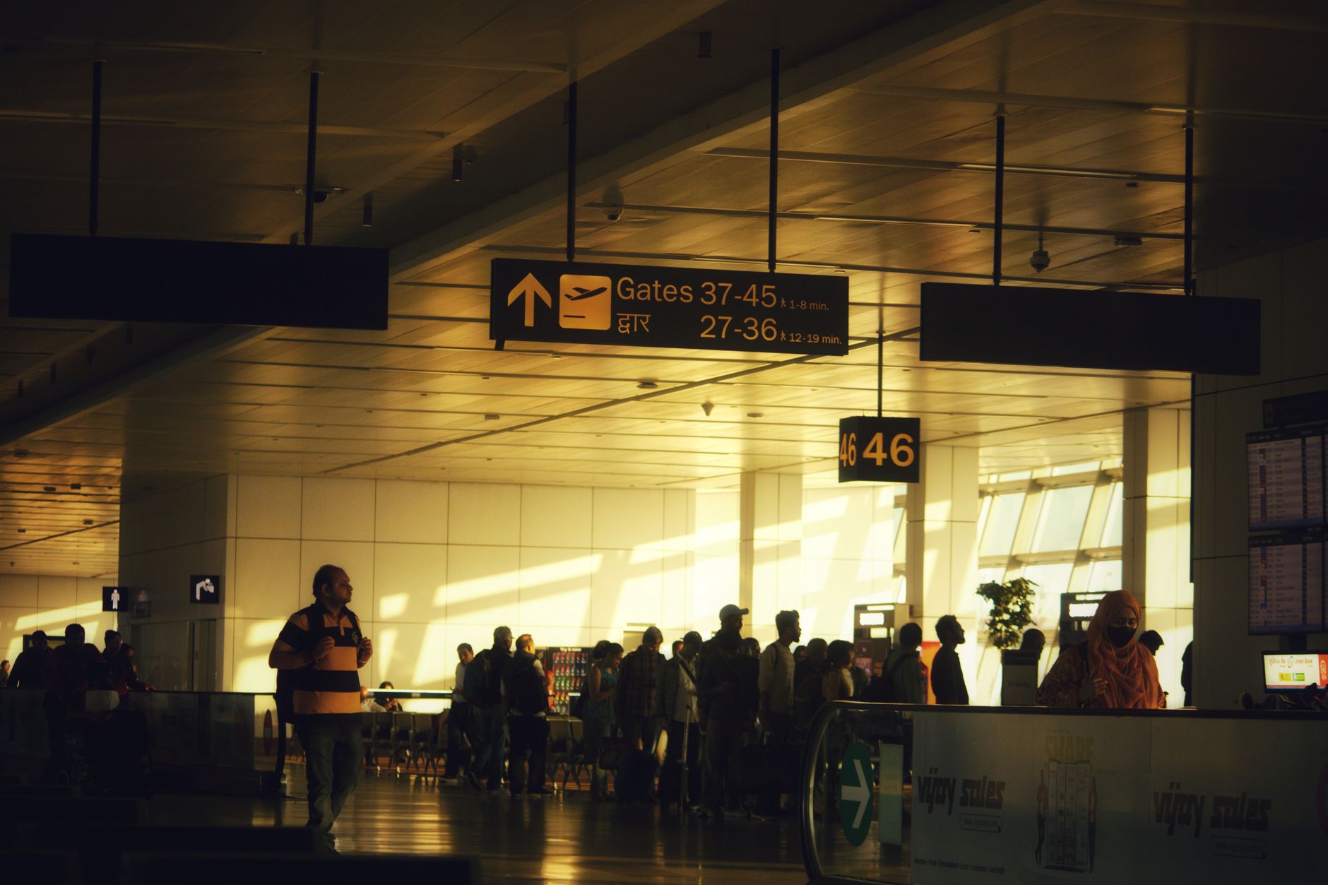 A clear airport gate sign inside a terminal supports the article's focus on simple rider-directed navigation to the gate.