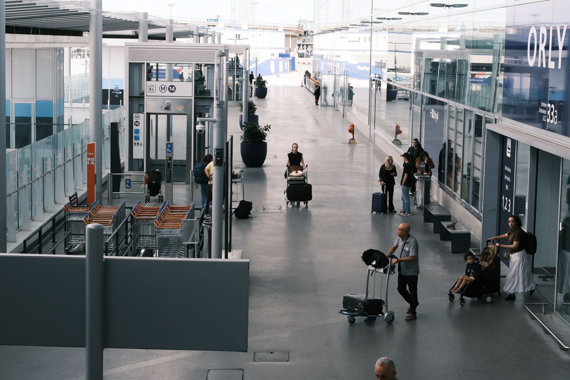 Travelers move through a long airport concourse, setting the scene for mobility support across extended gate runs.
