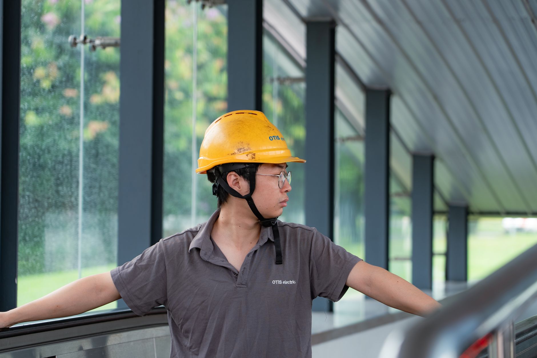 A field engineer in safety gear reviewing work on site, representing the consolidated capture and review role described in the program.