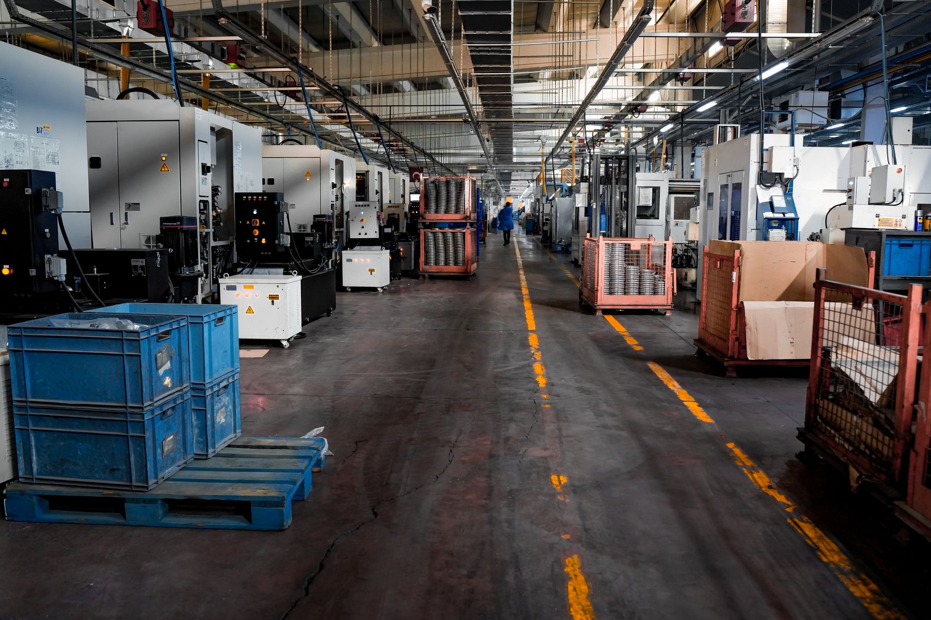 Sealed cartons traveling down a food packing conveyor, illustrating the handoff point where palletizing was removed from operators.