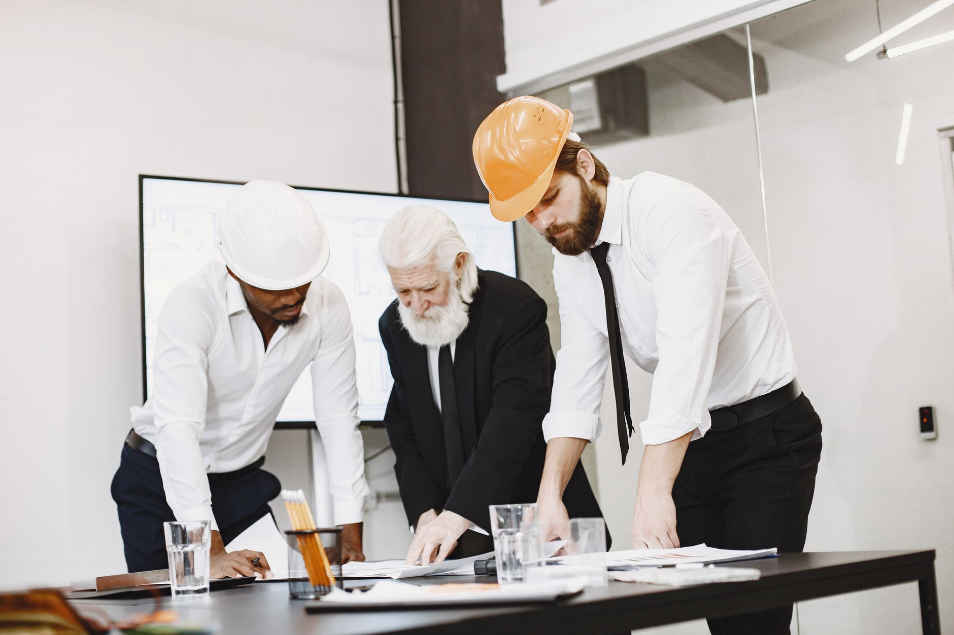 Contractors review construction plans together while preparing a coordinated field deployment.