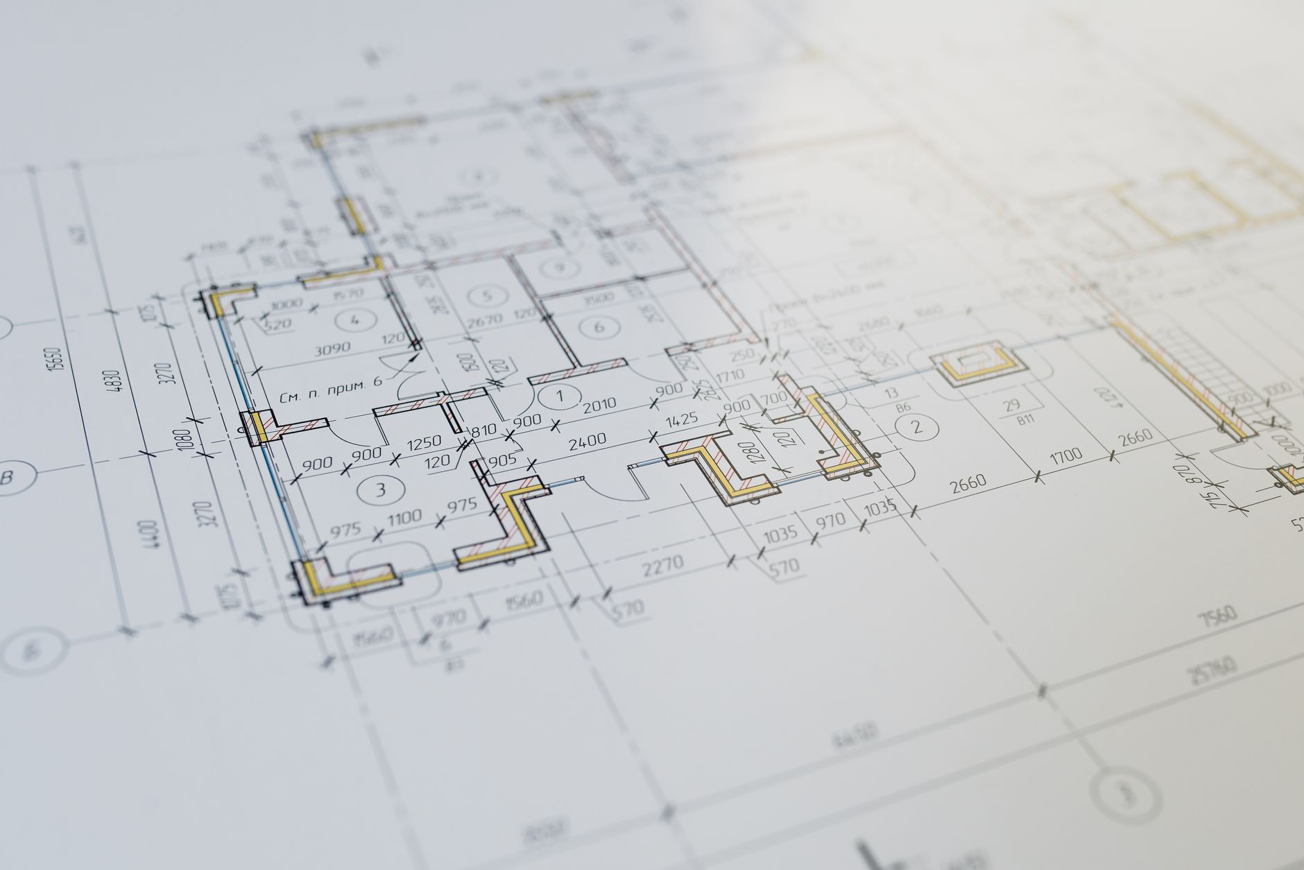 Construction drawings spread out for review before coordinated field layout begins.