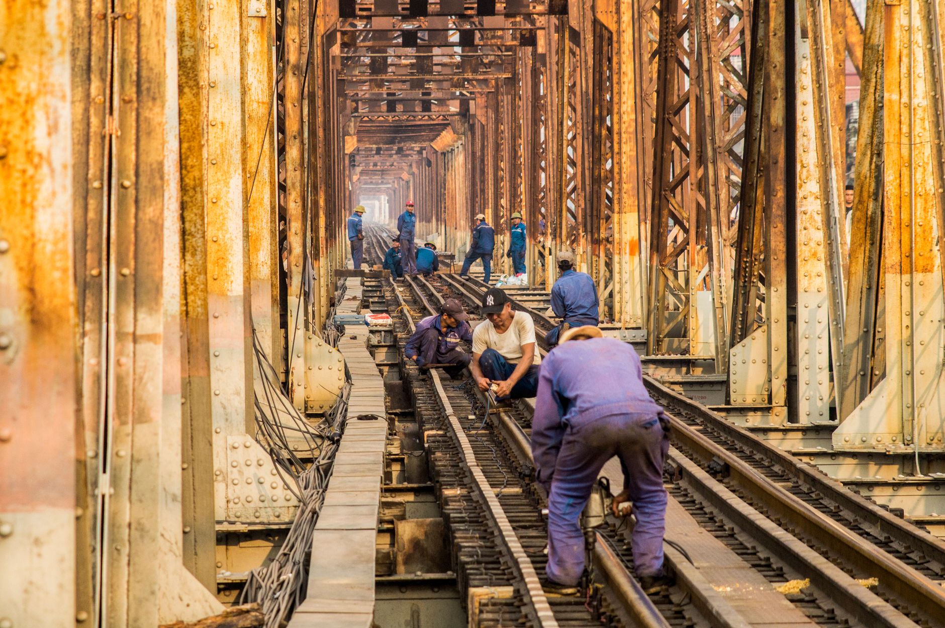 Rail maintenance workers examine track infrastructure during a manual inspection round.