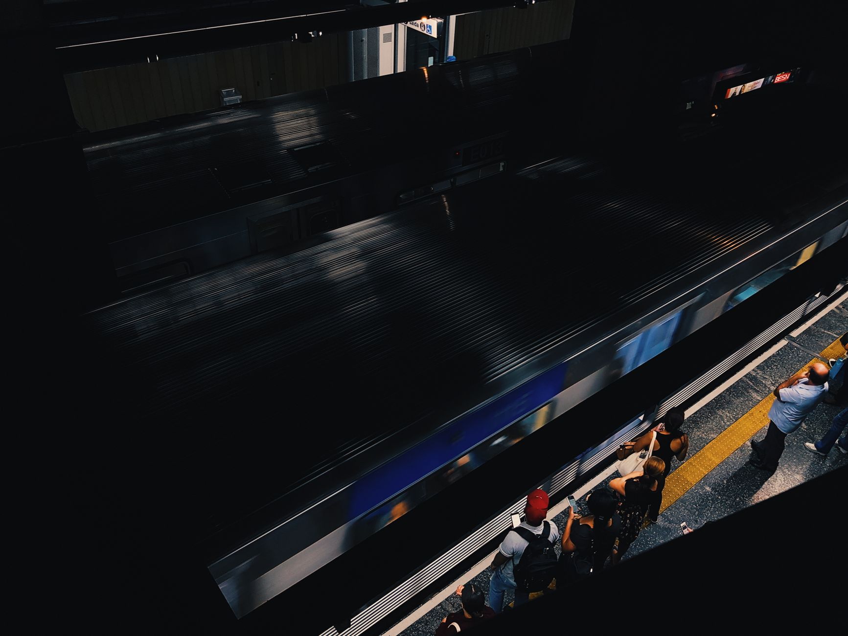 Commuters move through a busy metropolitan rail platform during daily service.