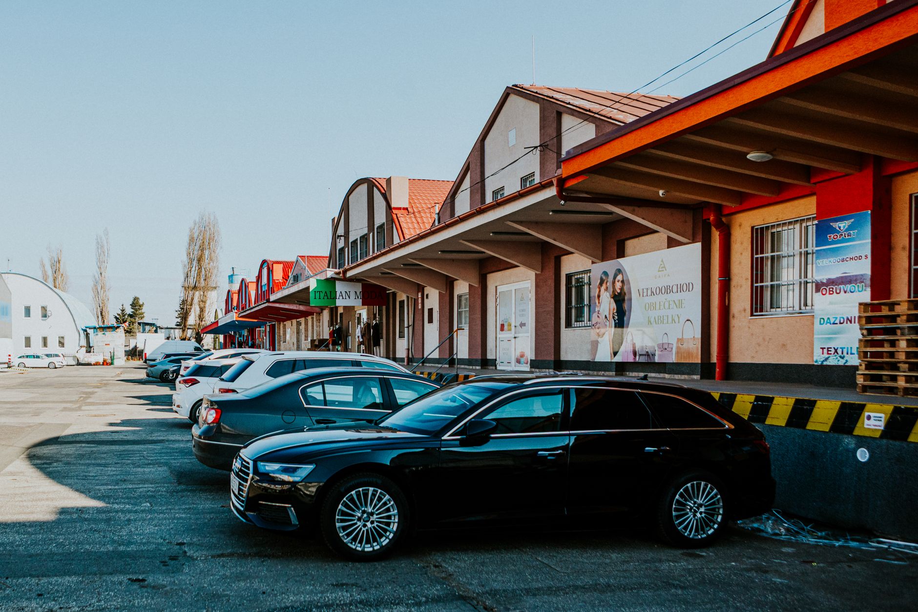 An outdoor strip retail parking lot where property teams face break-ins and loitering after dark.