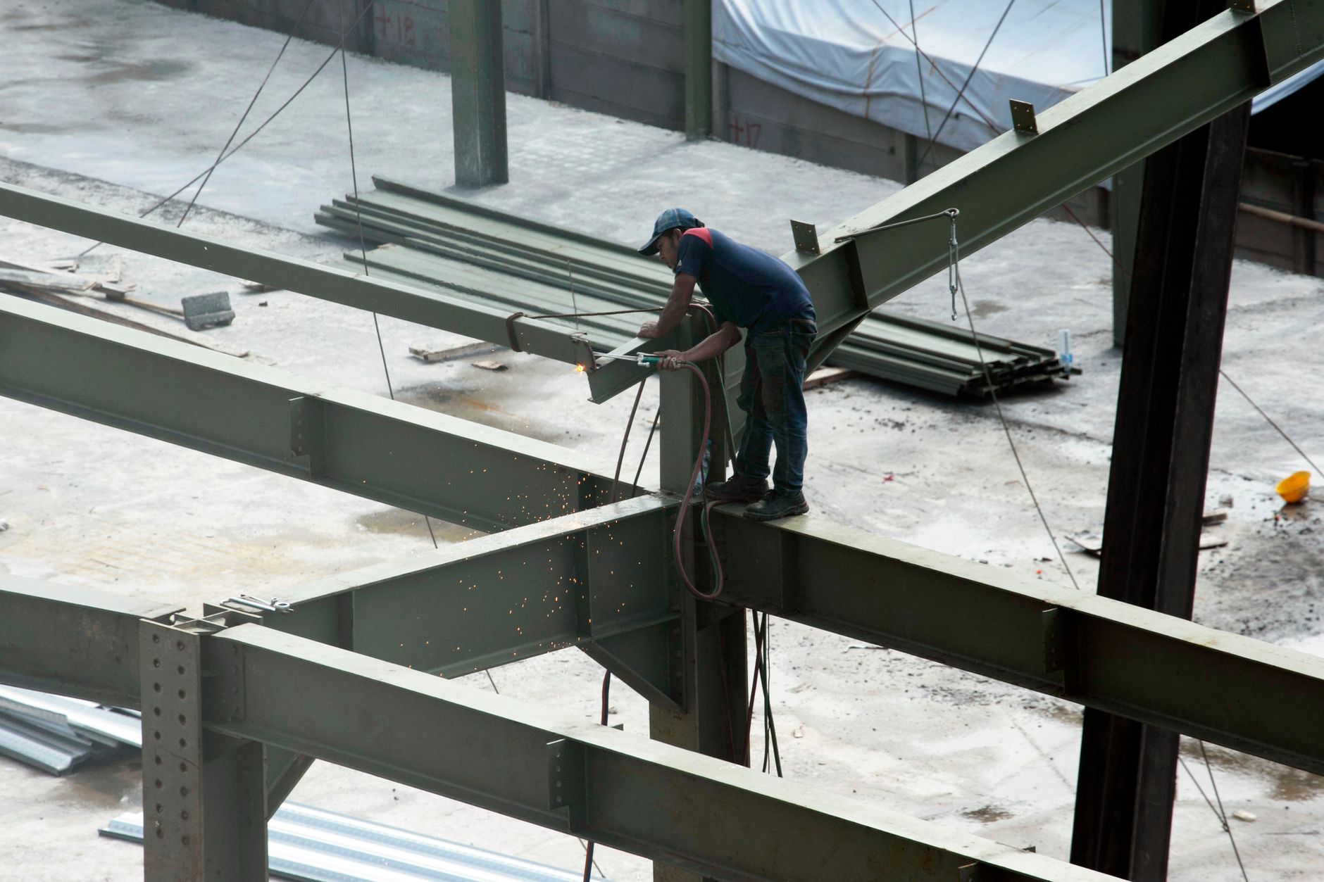 Steel frames prepared for spot welding in a heavy manufacturing environment.