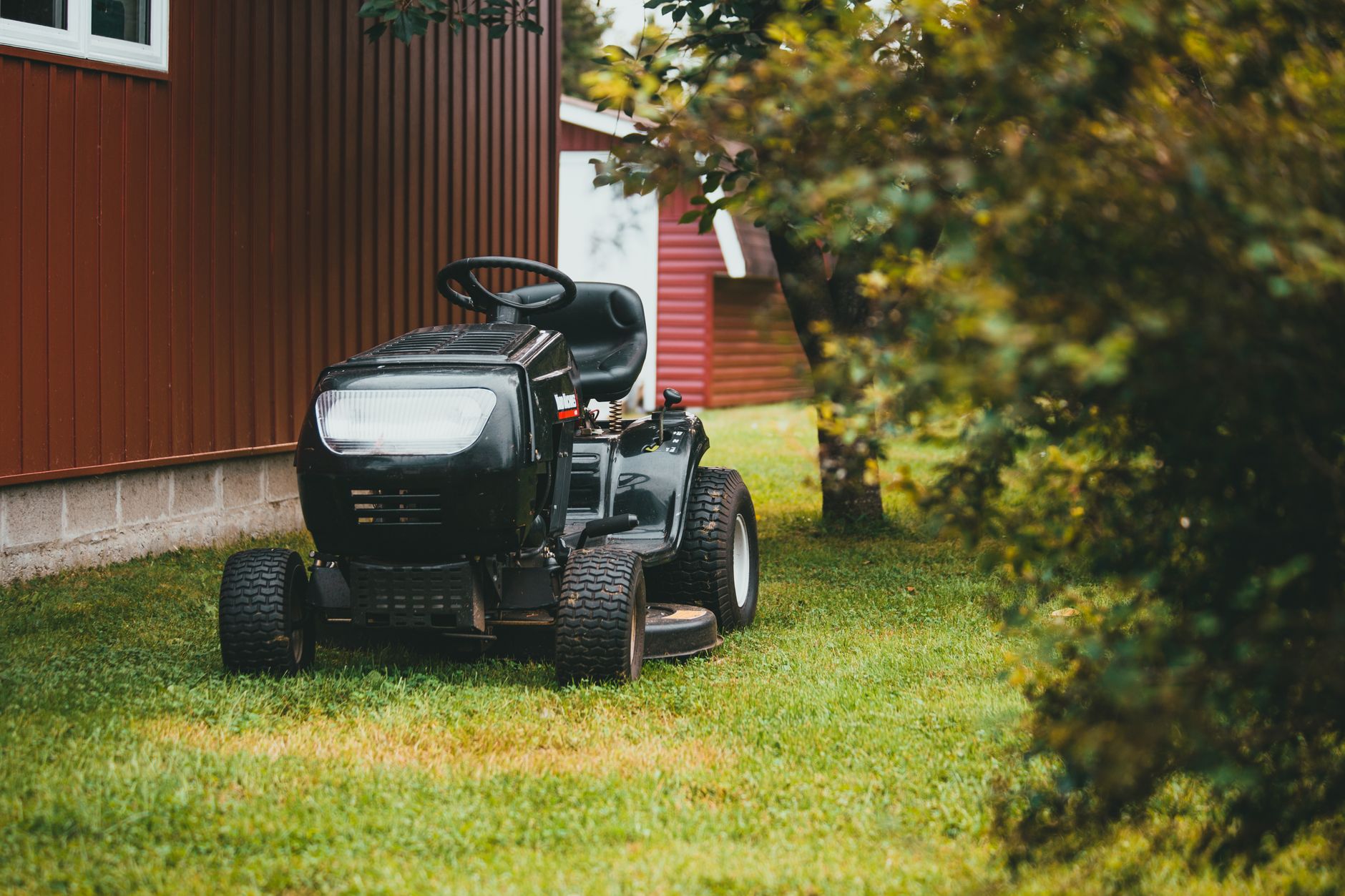 Traditional fuel-powered mowing equipment used on large turf areas before automation.