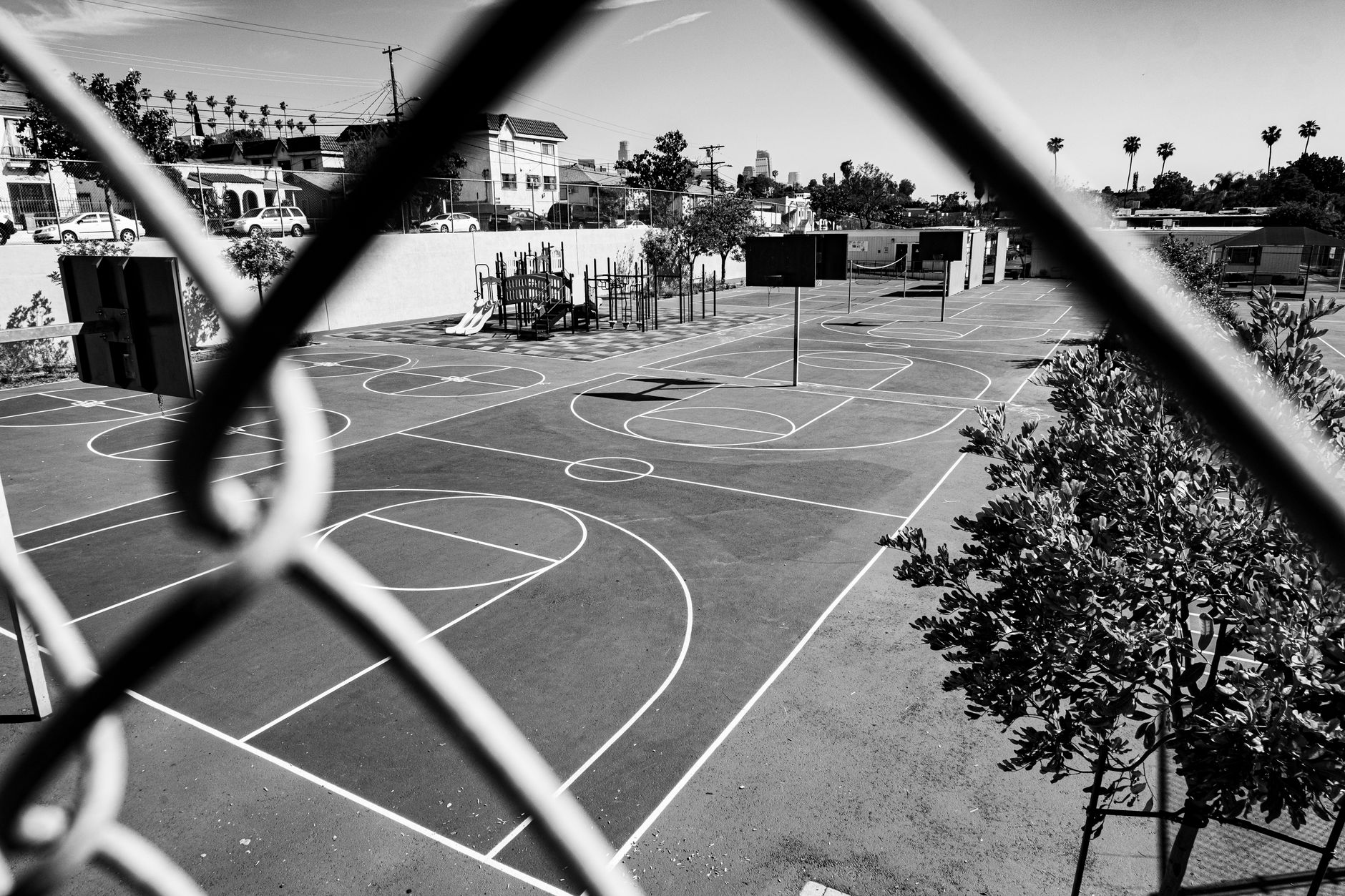 Empty twin basketball courts in a recreation center ready for evening league play.