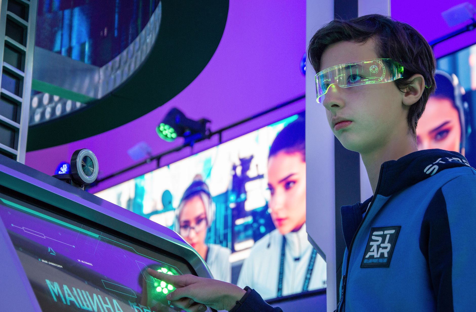 A visitor uses an interactive display while exploring a museum exhibition.
