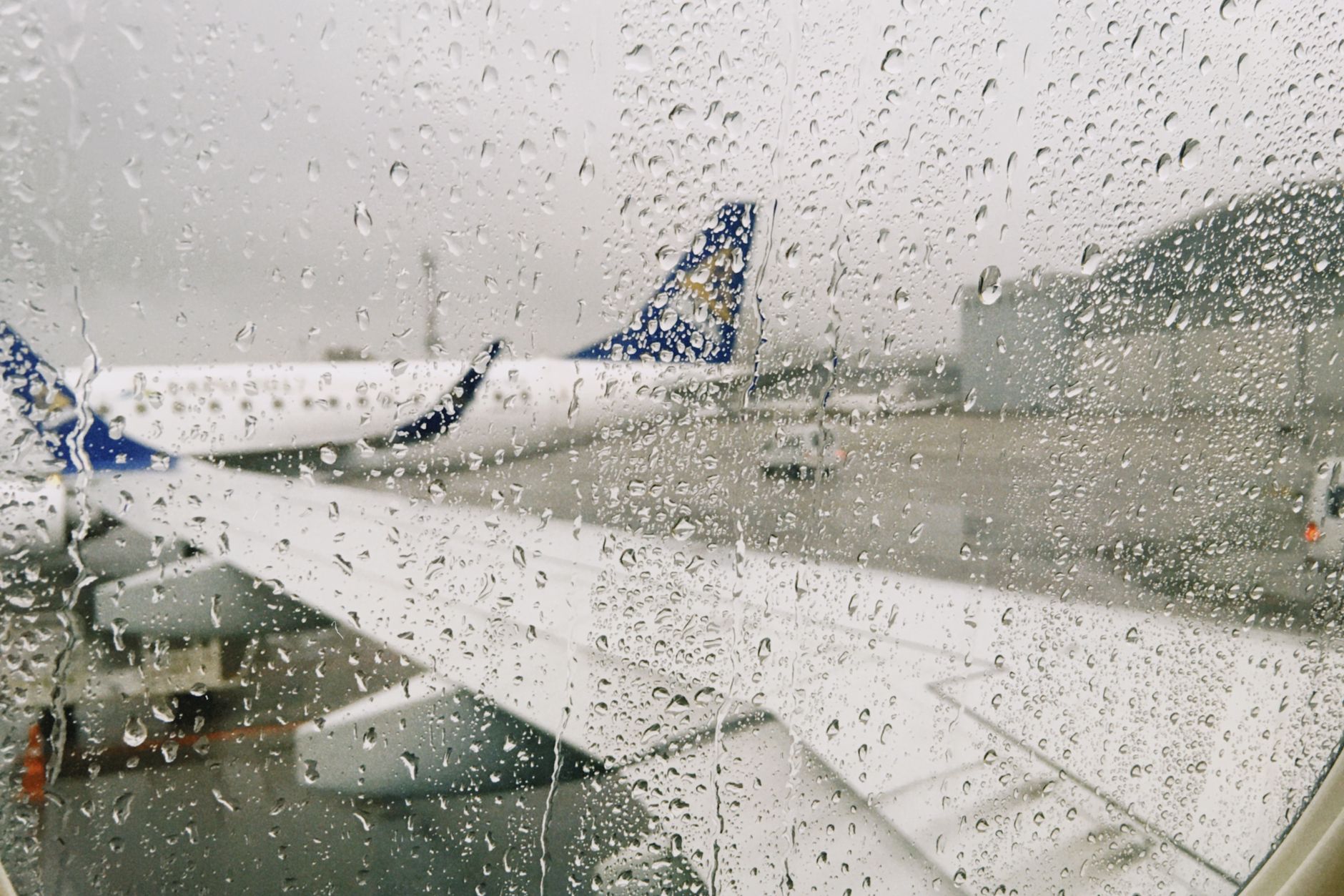 View from an airport terminal window toward the airfield, illustrating the scale of facilities that rely on consistent floor care.