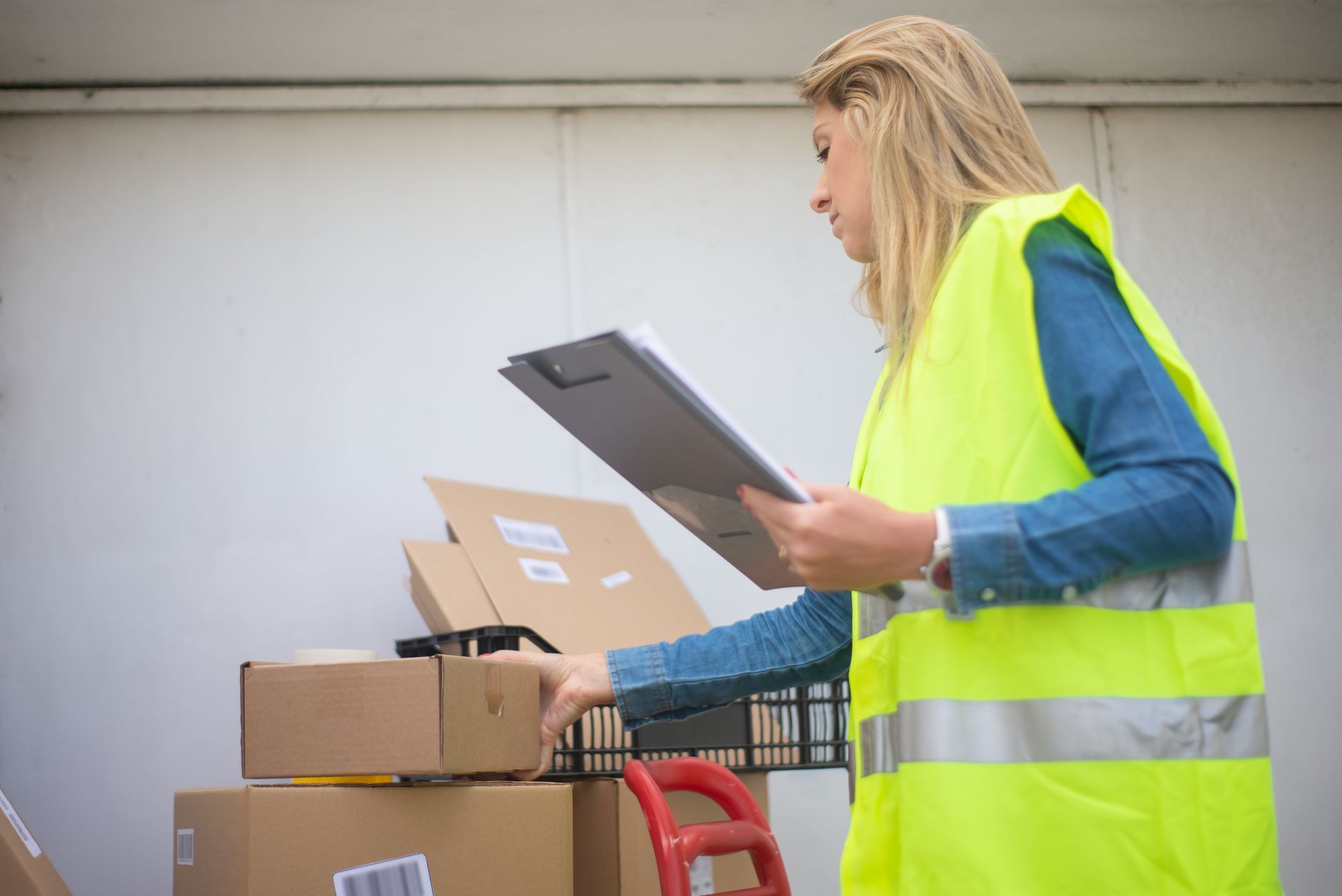 Cardboard parcels stack in a busy distribution area where pick accuracy and throughput both matter.