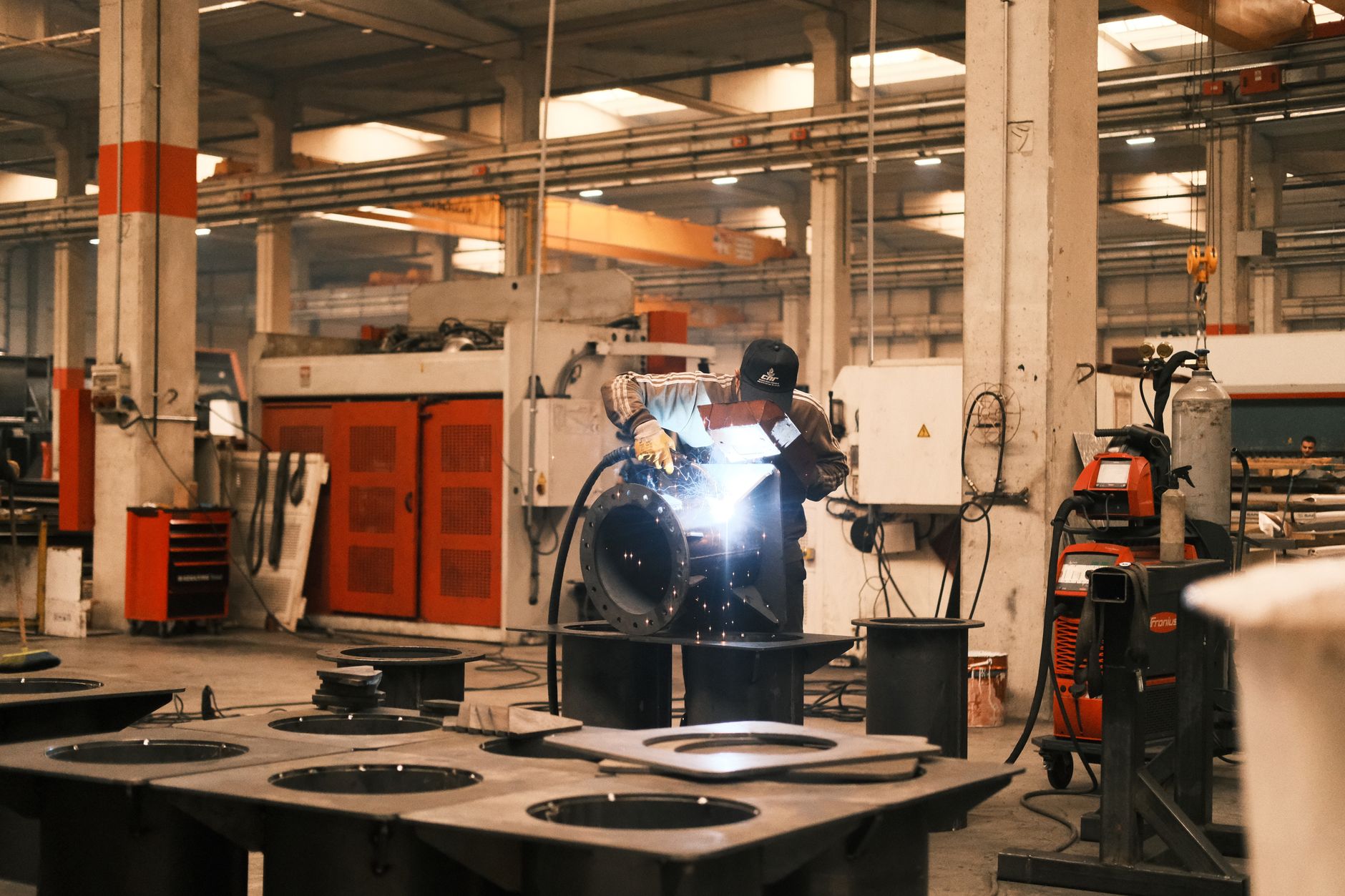 Welding activity in a manufacturing cell that depends on steady parts delivery from internal transport.