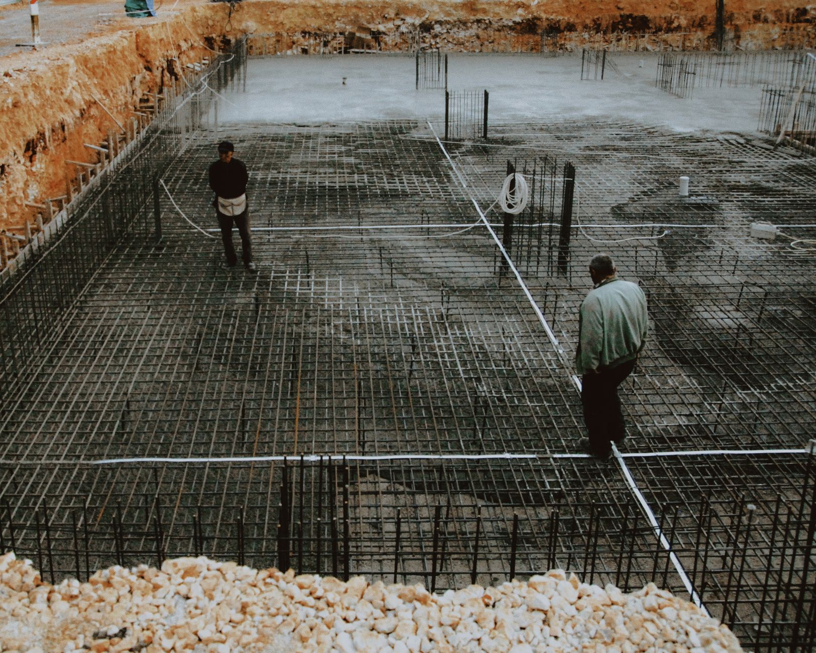 A facility worker inspecting the condition of a concrete parking deck during an on-site evaluation.
