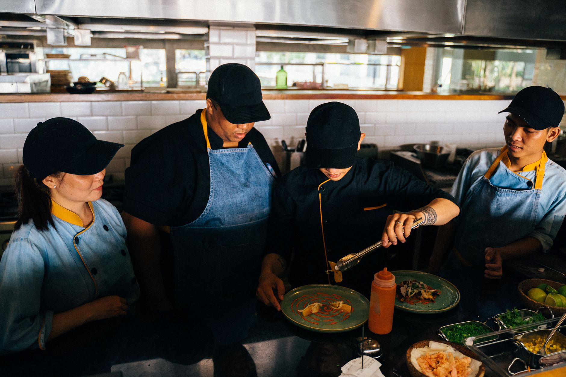 Restaurant staff gather for operational training before a busy service.