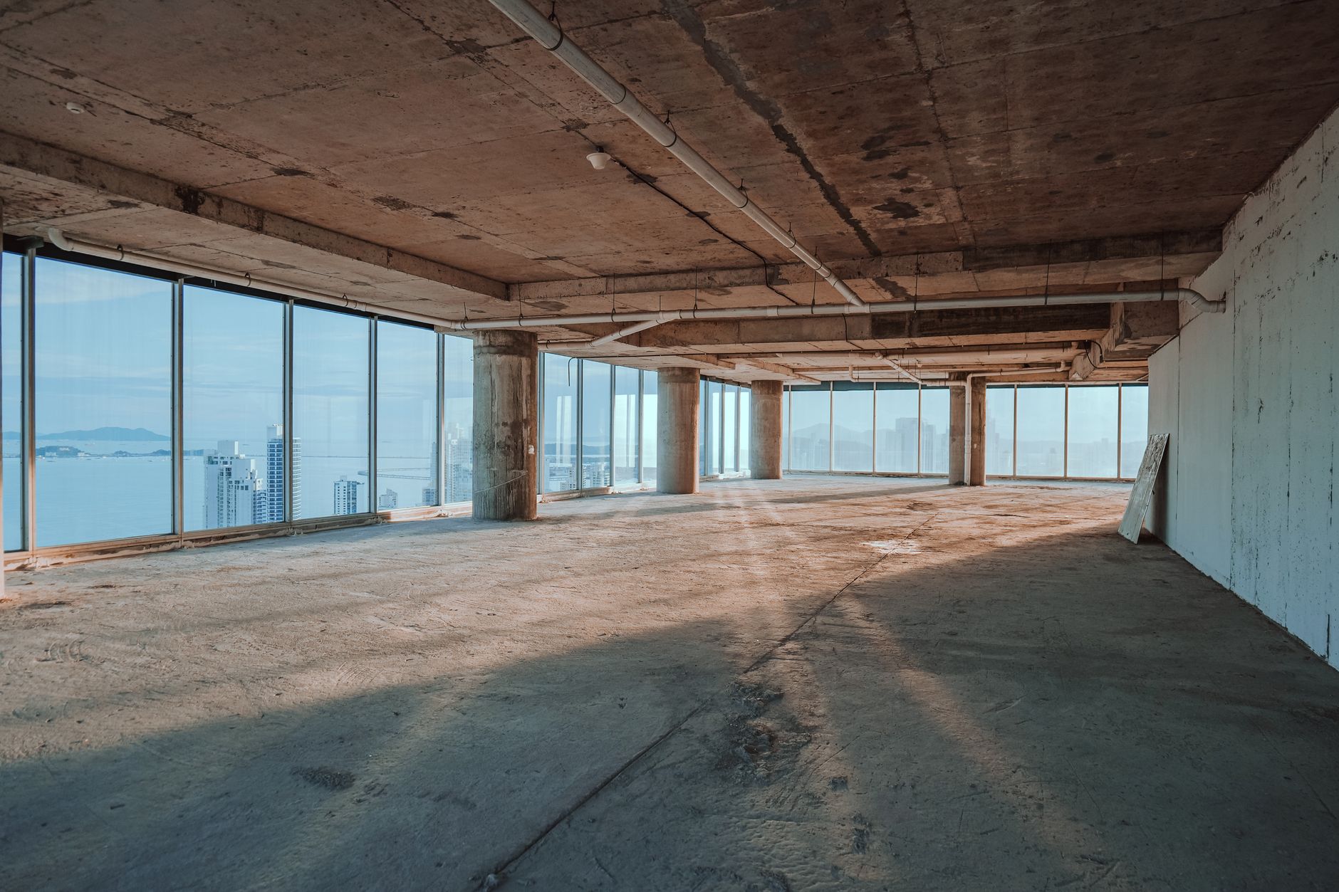 An unfinished commercial interior provides the open-wall setting for large-scale drywall finishing work.