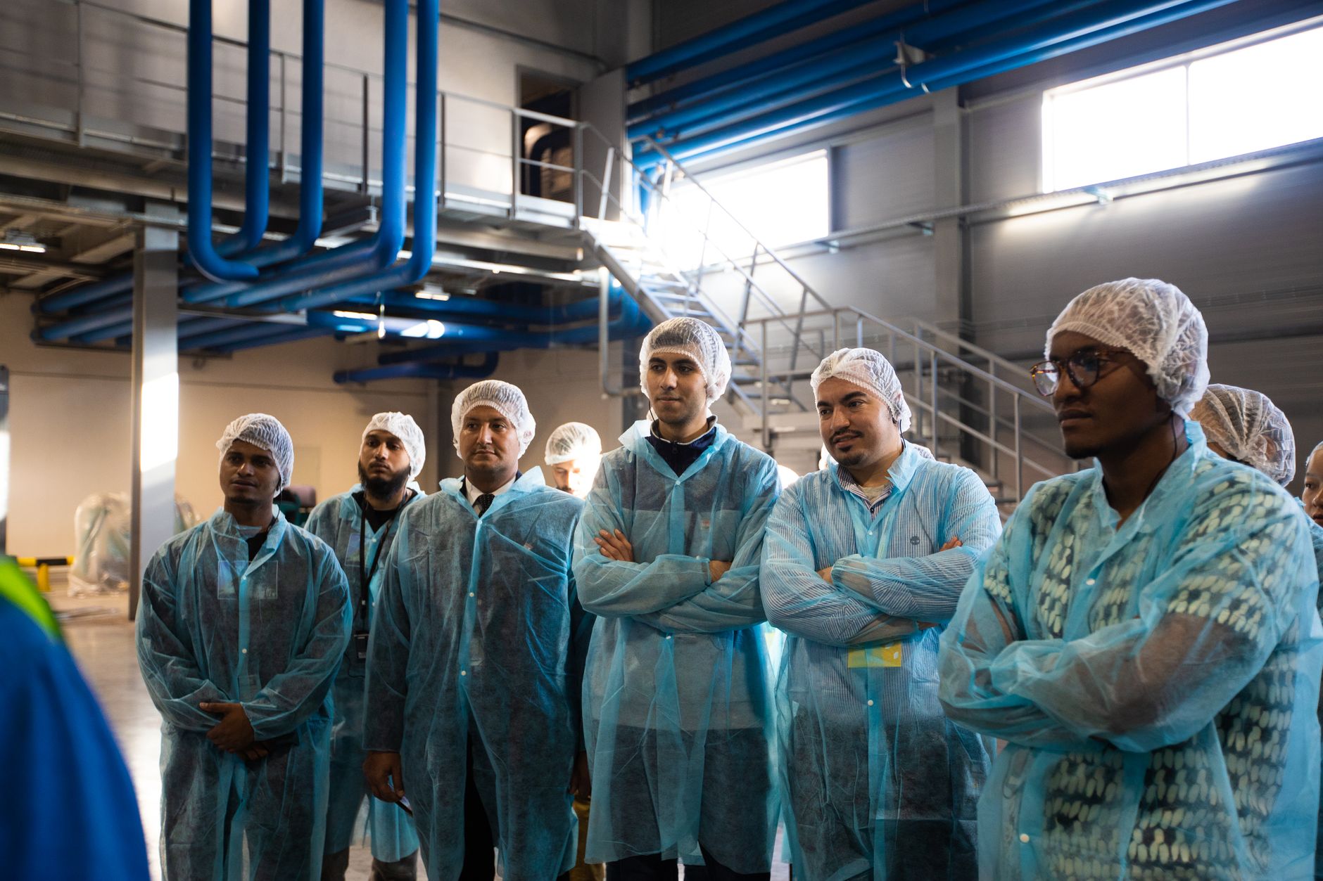 A manufacturing team reviewing work instructions on the shop floor, underscoring the article's point about easier onboarding and lifecycle support.
