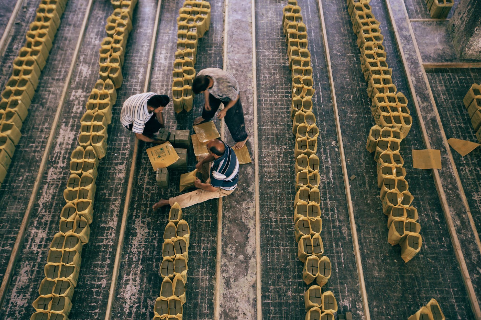 Workers at a consumer-goods packing station, reflecting the high-mix factory environment behind this personal-care assembly changeover story.