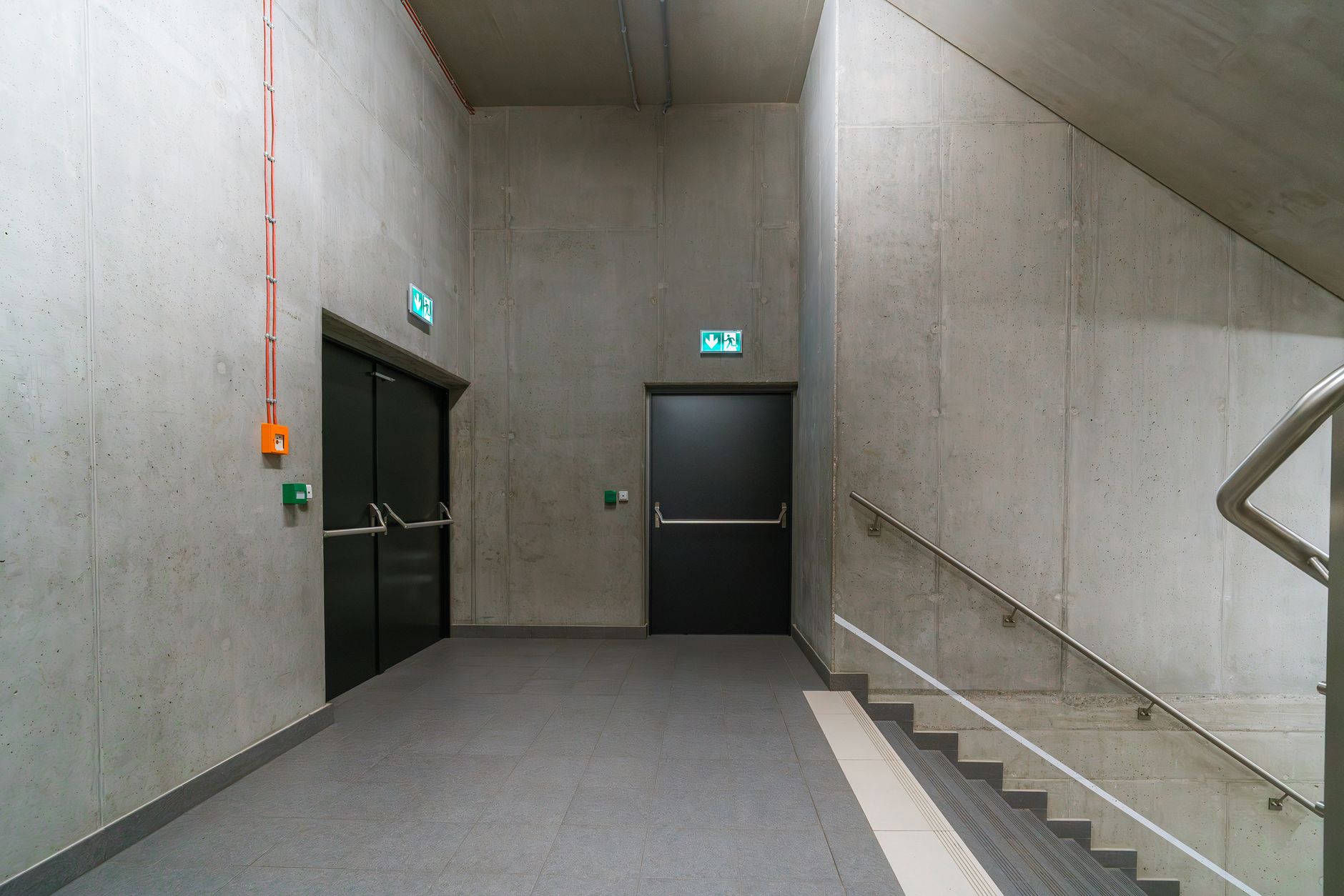 A long, clean factory corridor with reflective flooring under overhead lights.